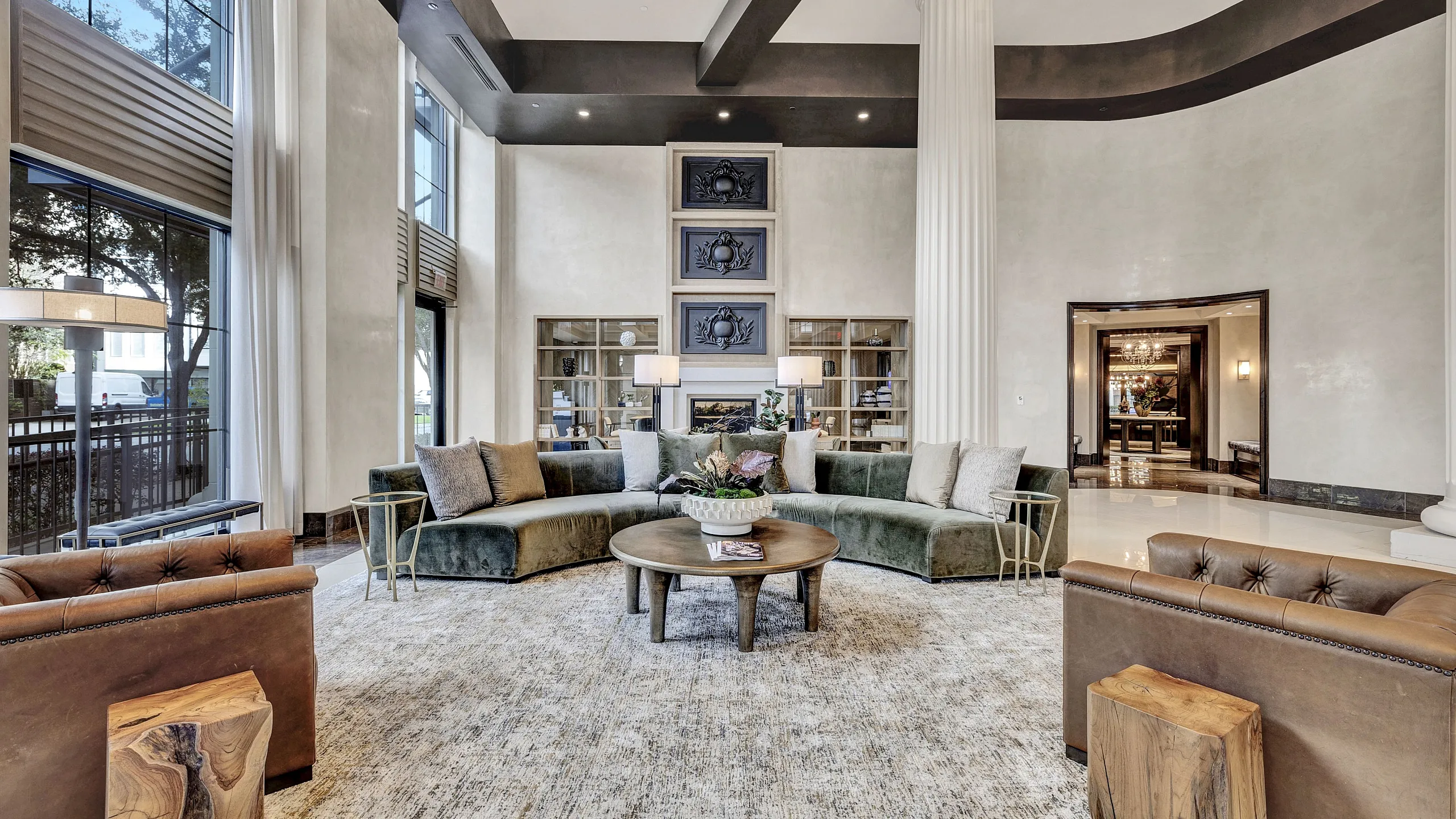 Elegant lounge with high ceilings, luxurious seating, and large windows creating a bright and inviting atmosphere.