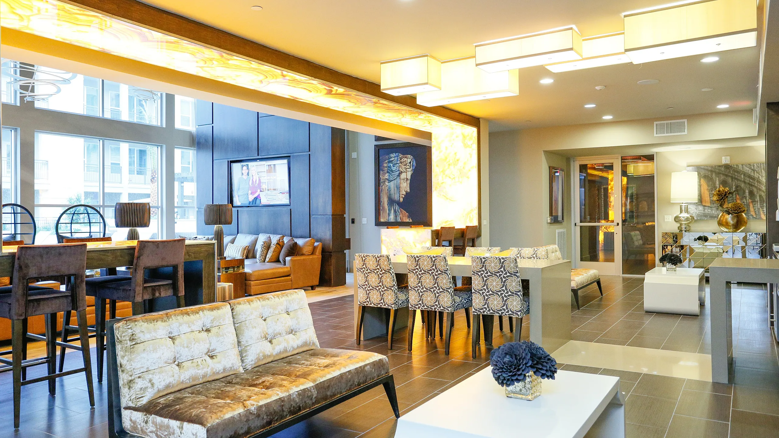 Luxurious open-concept lounge area with stylish furniture, modern lighting, and vibrant artwork, perfect for relaxation and entertaining.