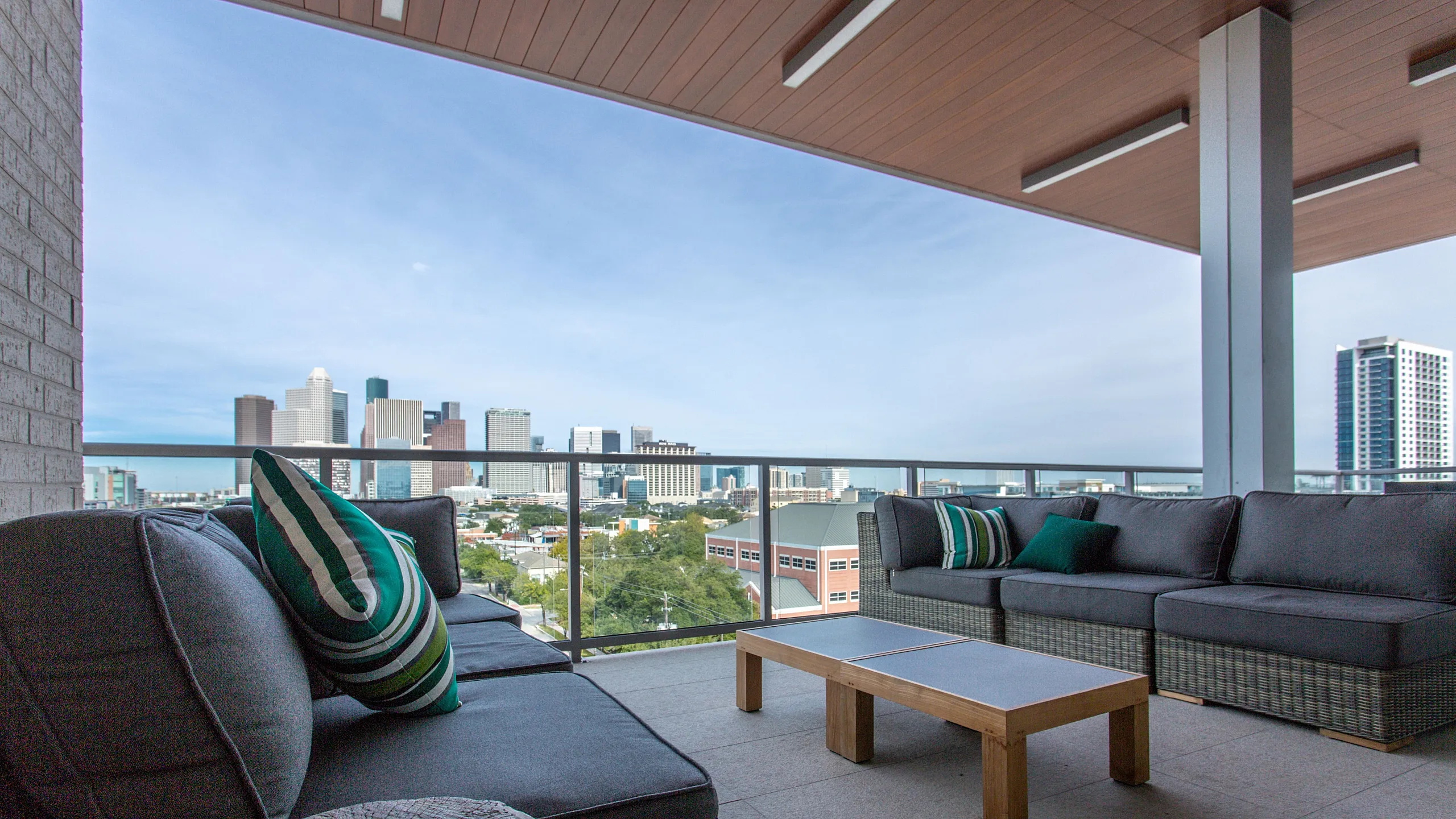 Chic outdoor terrace with modern seating offering breathtaking city skyline views.