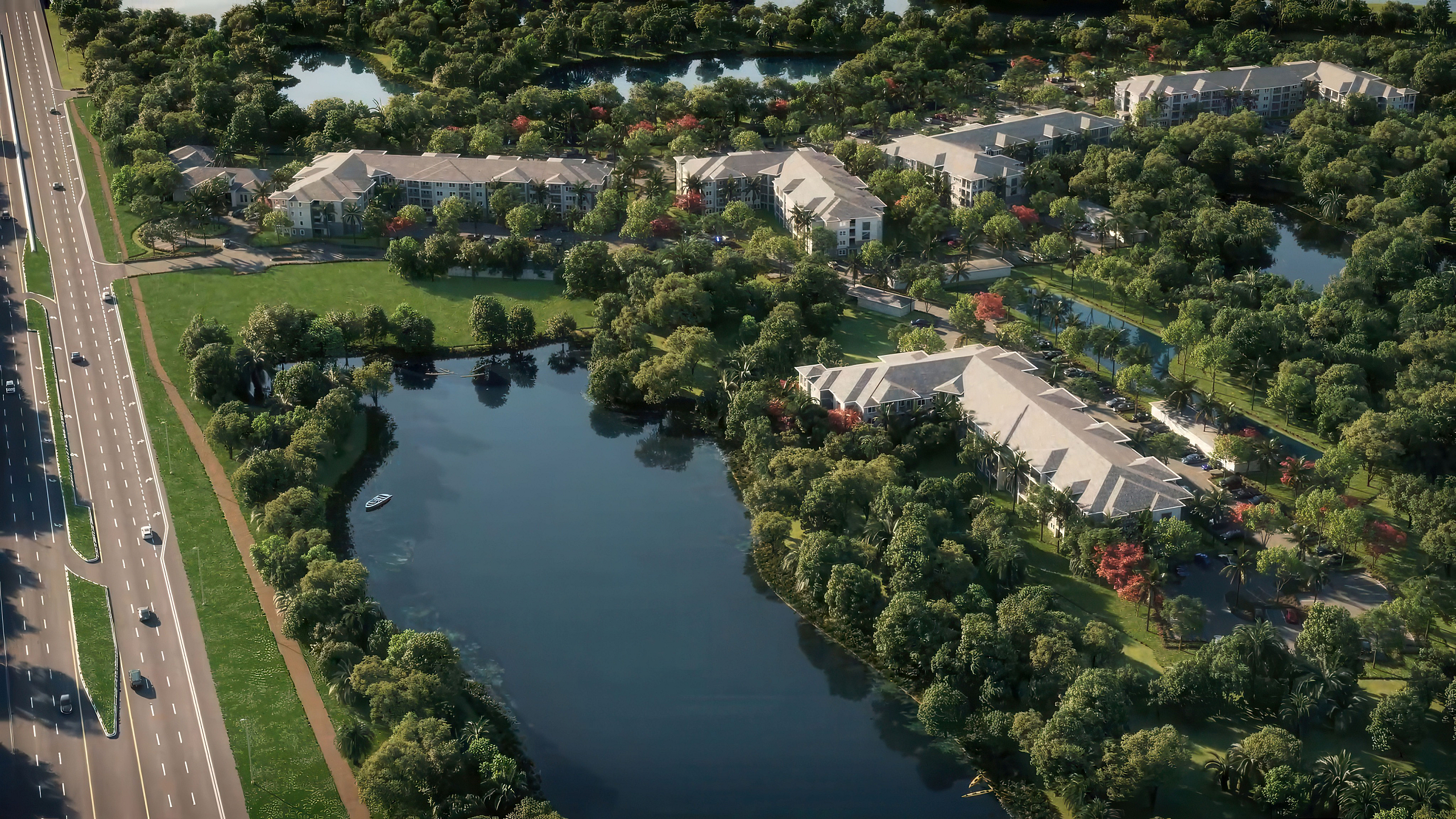 Aerial view of a serene residential community surrounded by lush greenery and a tranquil lake, highlighting modern buildings and tree-lined streets.