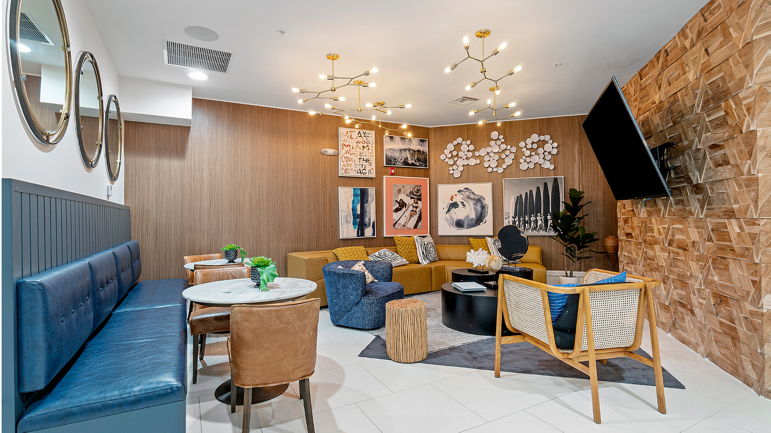 Elegant lounge area with modern decor, featuring stylish seating, unique wall art, and chic lighting fixtures.