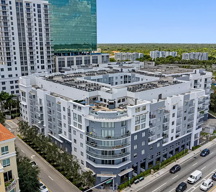 Modern urban apartment complex with sleek architecture and lush surroundings, offering luxurious living in a vibrant neighborhood.