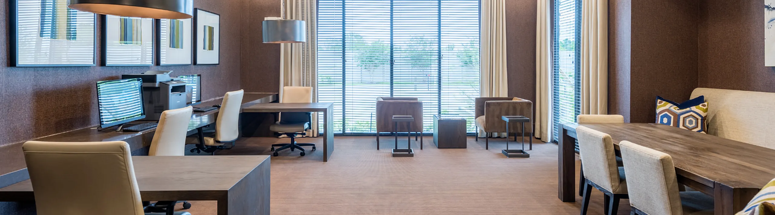 Modern co-working space with elegant decor, ample natural light, and comfortable seating options.
