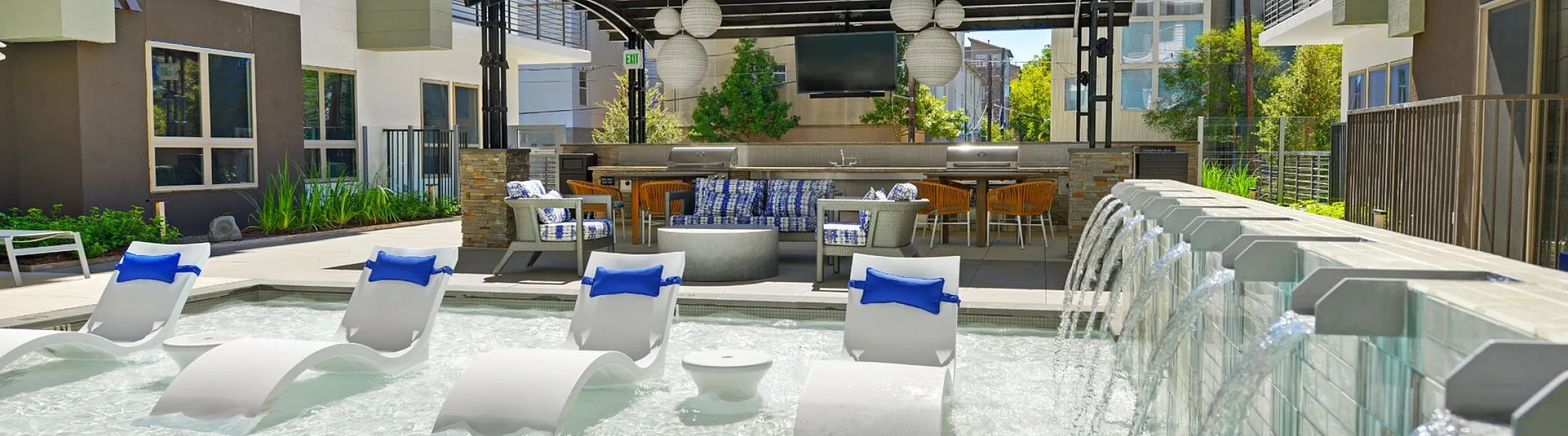Pool sun shelf with lounge chairs, waterfall wall and cabana, Houston, TX