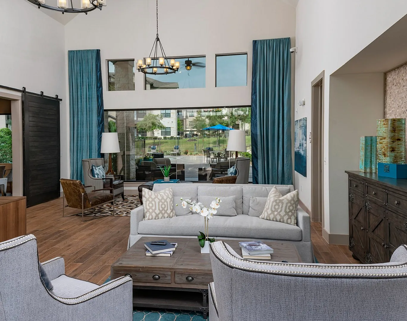 Clubhouse lounge with chandelier, sofas and floor-to-ceiling windows