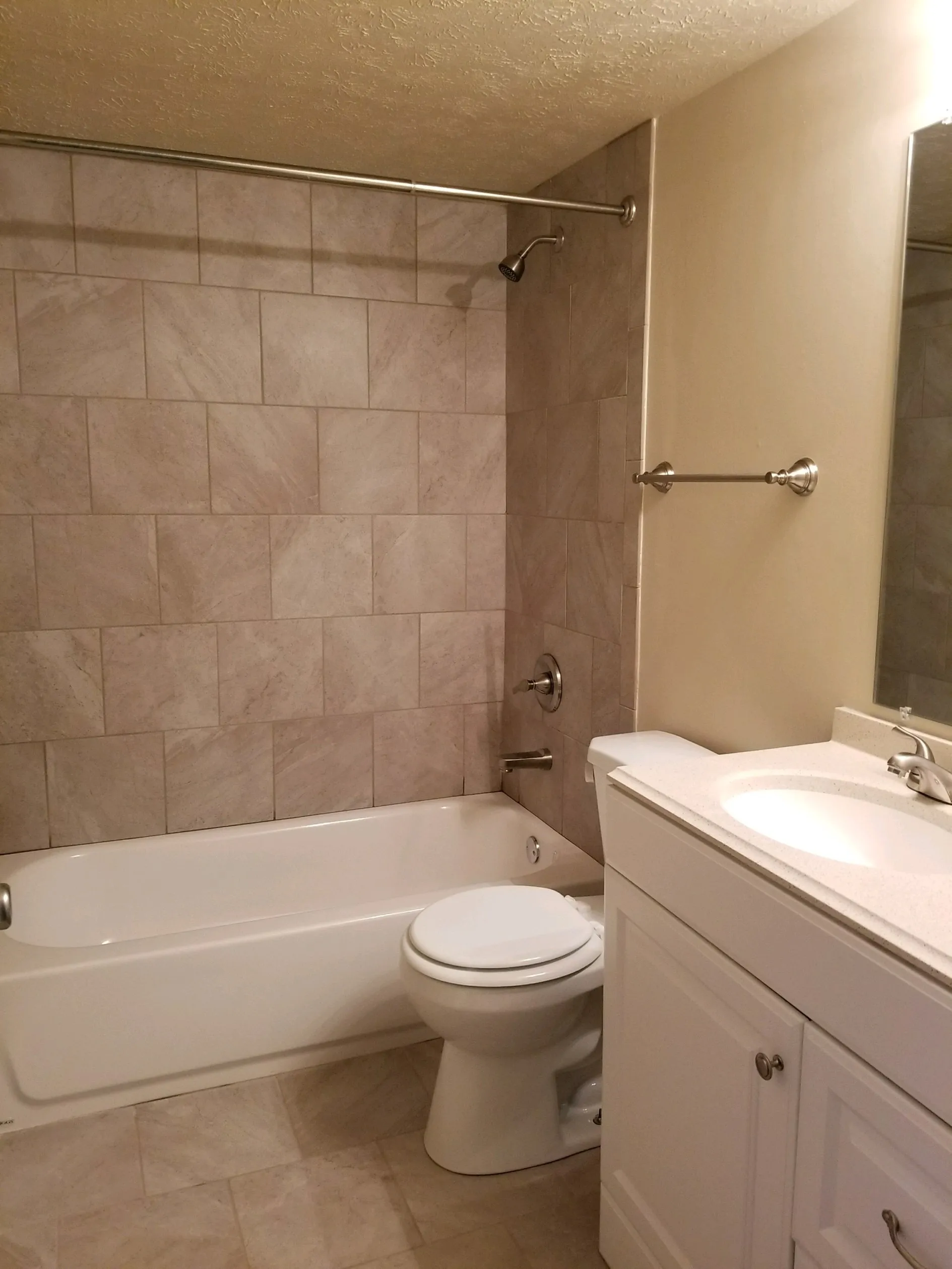 Cutom Bathroom with Marble Tile Surrount and solid surface vanity