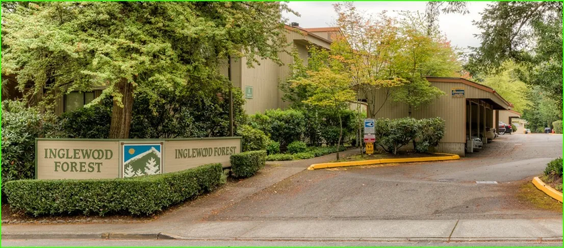 Charming entrance of Inglewood Forest Apartments surrounded by lush greenery and inviting pathways.