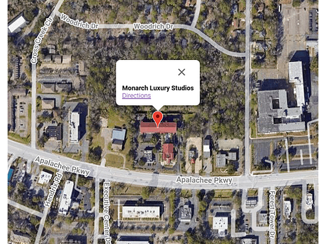 A zoomed-in satellite view highlighting Monarch Luxury Studios, located amidst a lush, green neighborhood.
