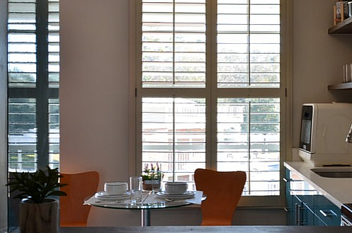 Charming kitchen and dining nook with natural light, modern fixtures, and cozy seating.