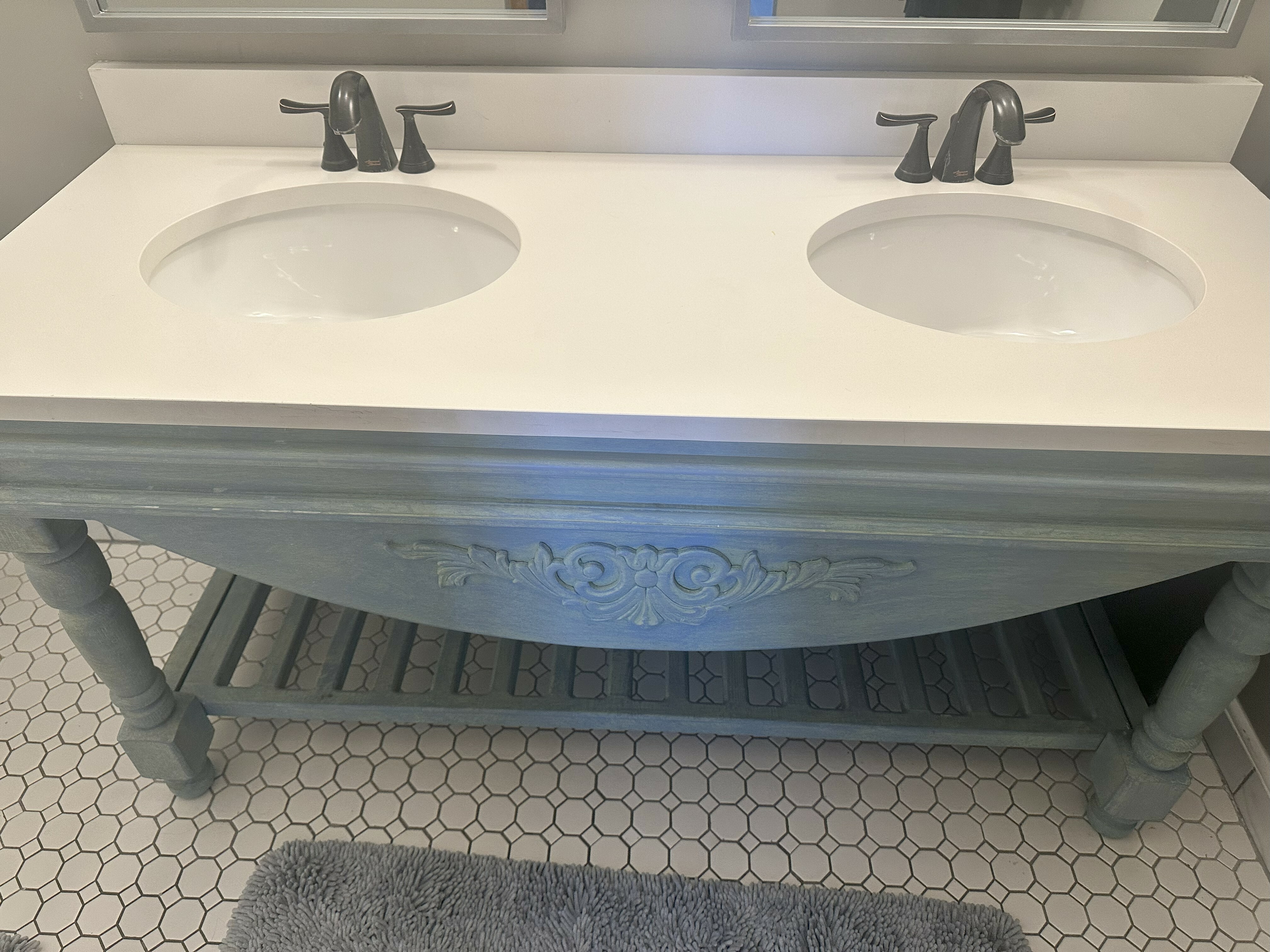 Elegant bathroom with a chic double-sink vanity and stylish hexagonal tile flooring.