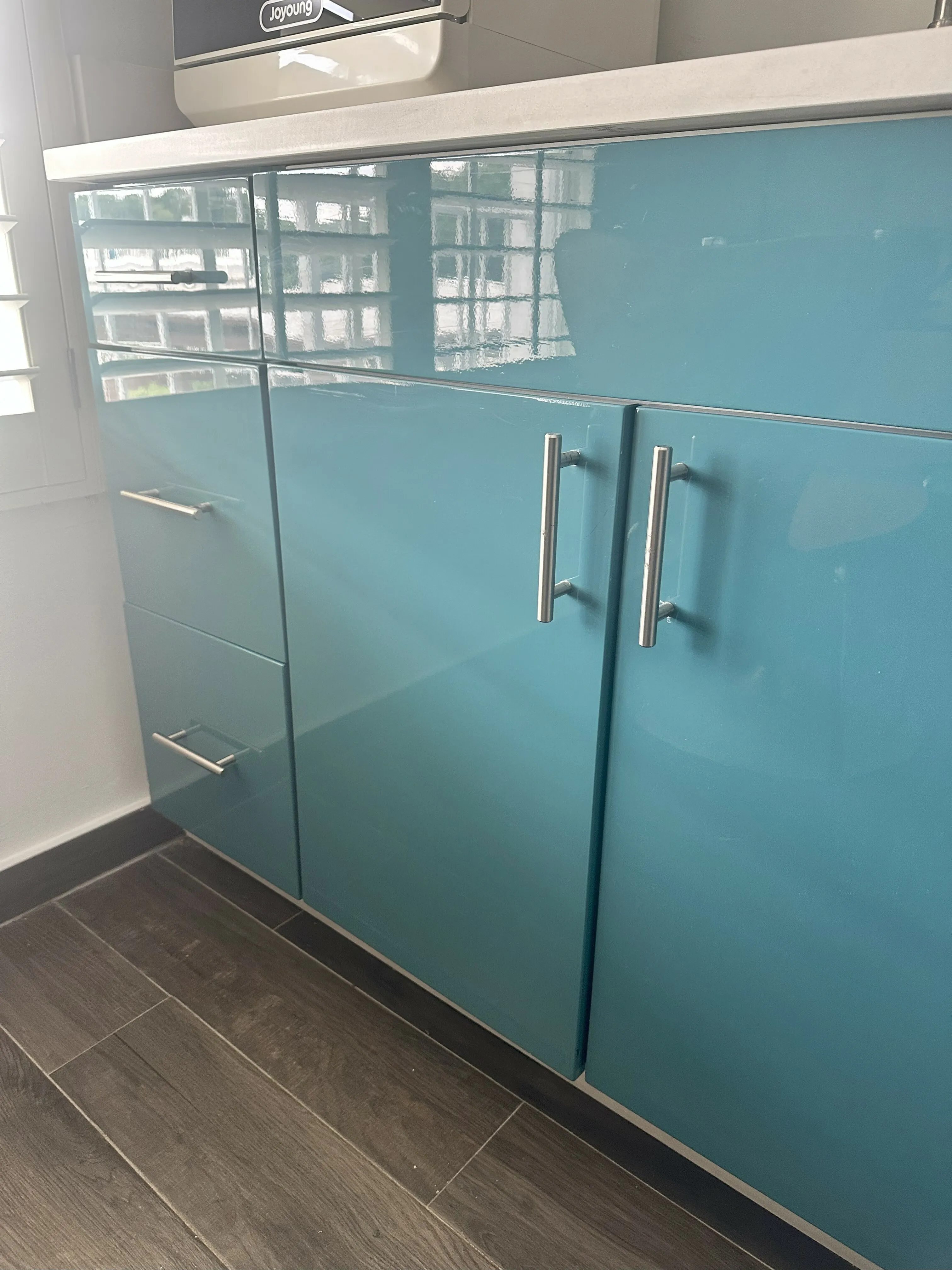 Modern kitchen with sleek blue cabinetry and stylish handles, emphasizing contemporary design and elegance.