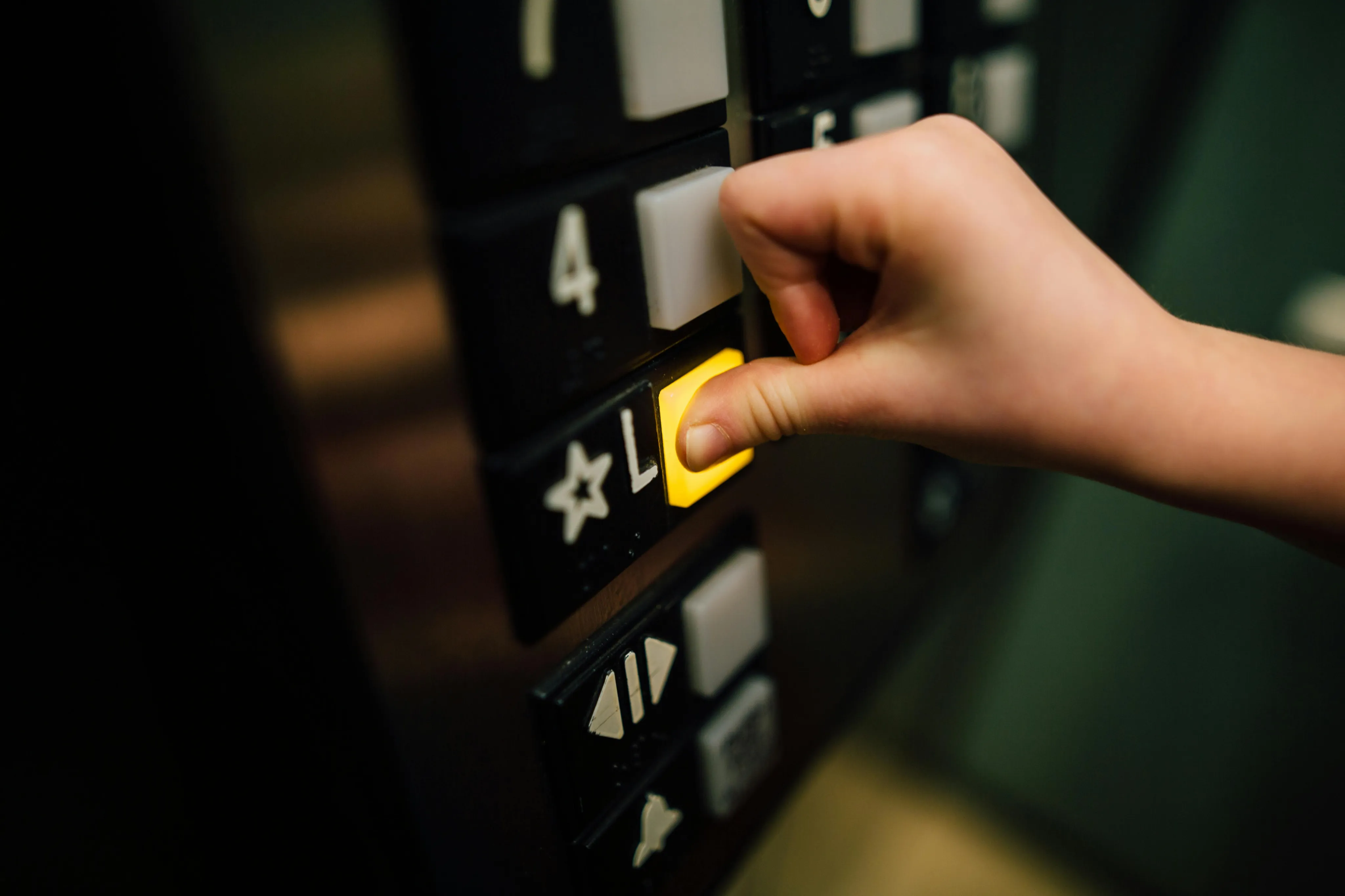 Inviting elevator panel with a glowing button, symbolizing seamless convenience in a modern living space.