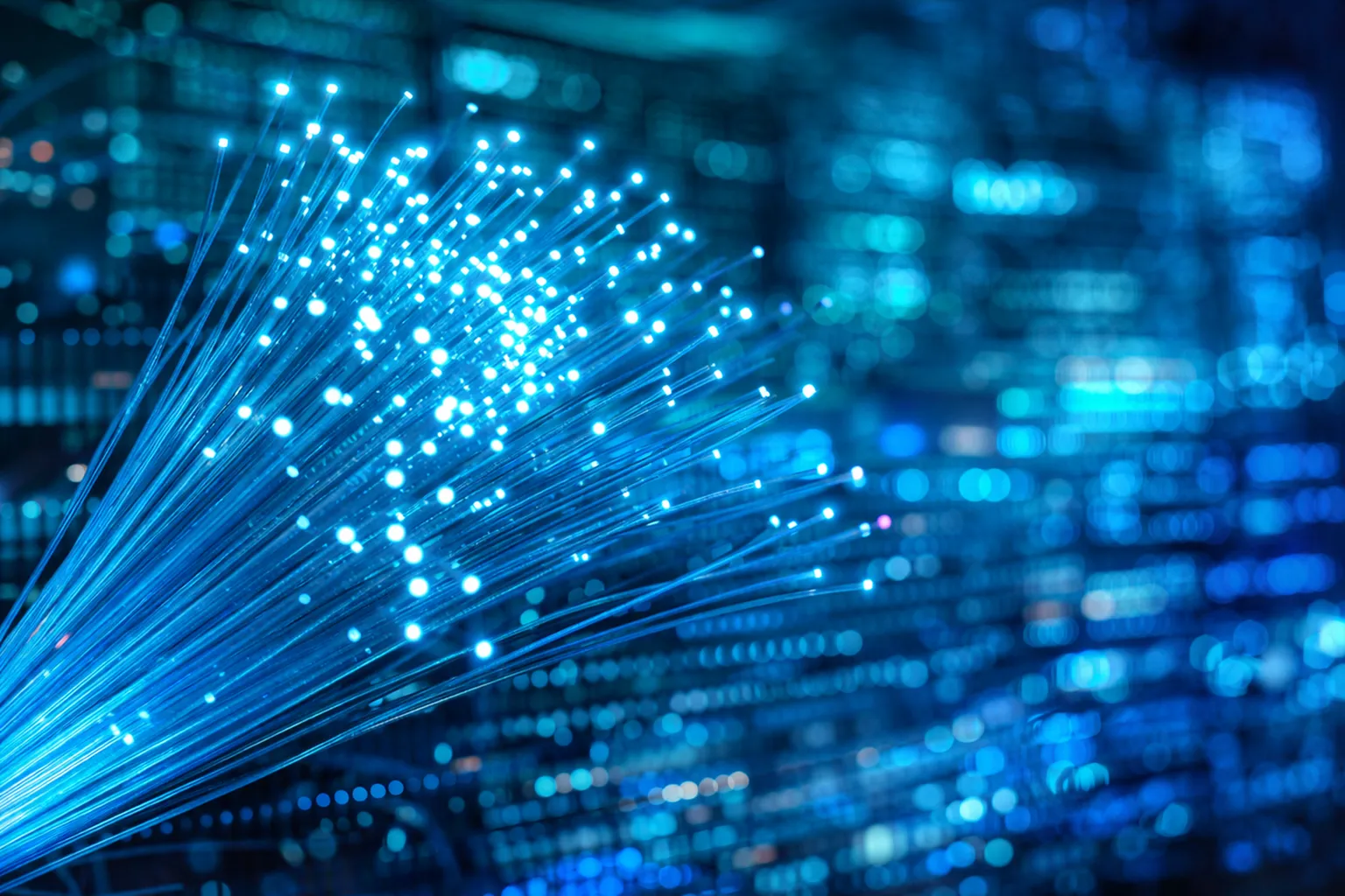 Dynamic display of glowing blue fiber optic cables against a high-tech digital backdrop, showcasing cutting-edge connectivity.