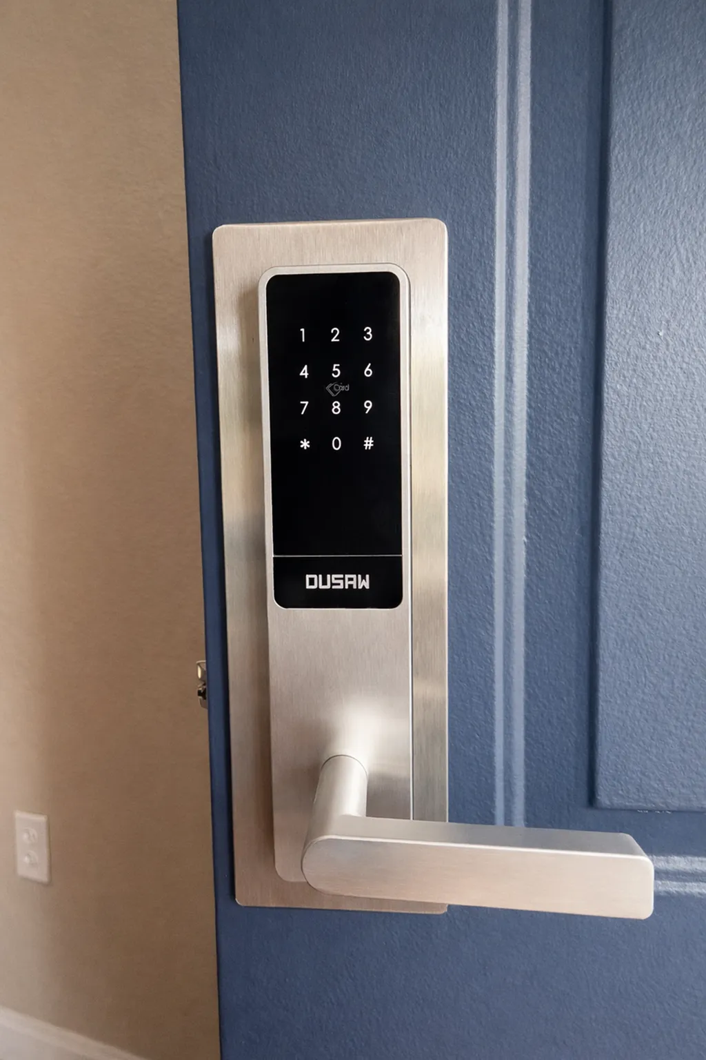 Sleek electronic door lock with keypad on a modern blue apartment door, offering security and contemporary style.