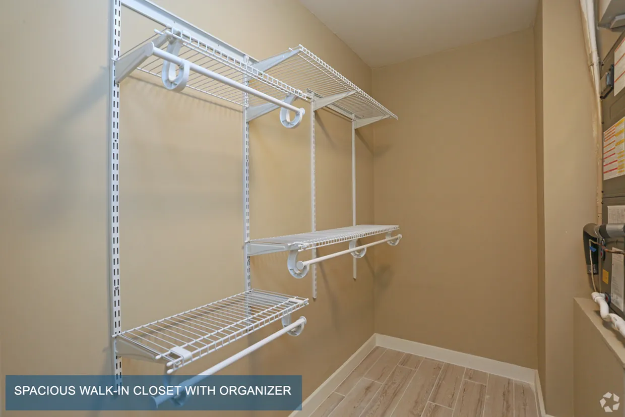 Spacious walk-in closet featuring built-in organizers and modern shelving for efficient storage.