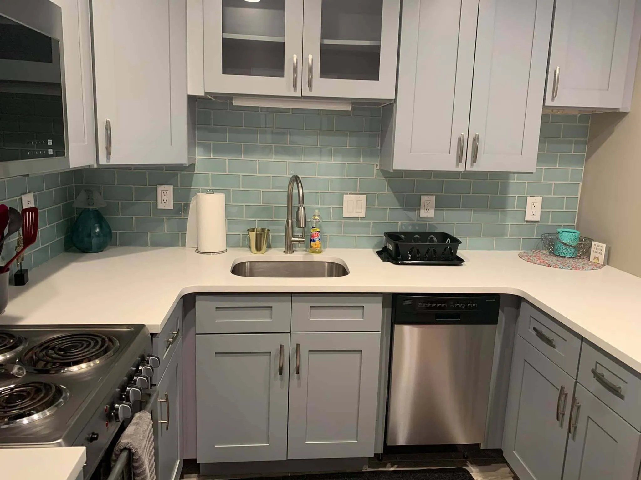 Charming modern kitchen with sleek cabinetry, stainless steel appliances, and a stylish tile backsplash.