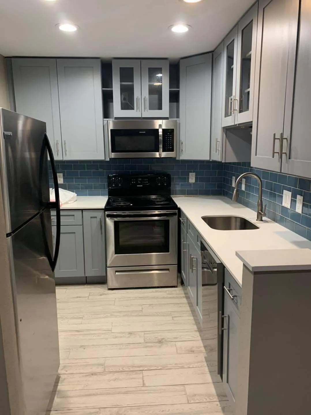 Modern kitchen with sleek stainless steel appliances, stylish cabinetry, and elegant subway tile backsplash.