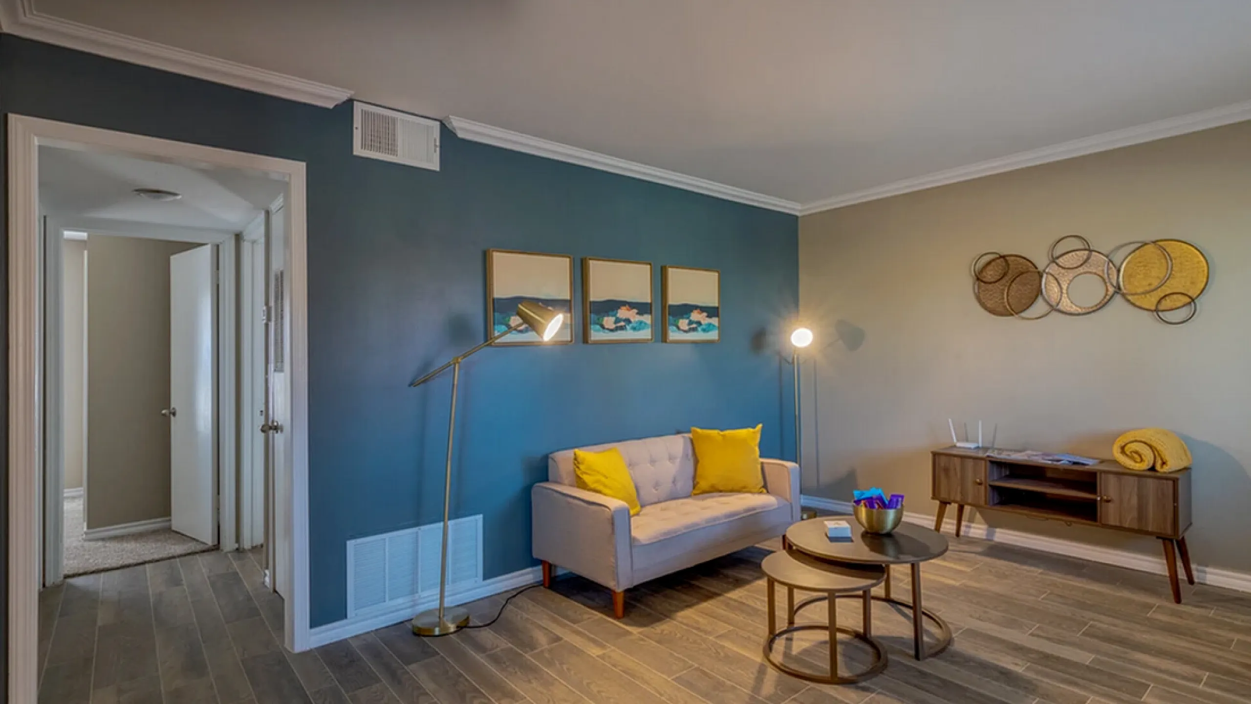 Chic living room with stylish decor, modern lighting, and cozy seating area in a contemporary apartment setting.
