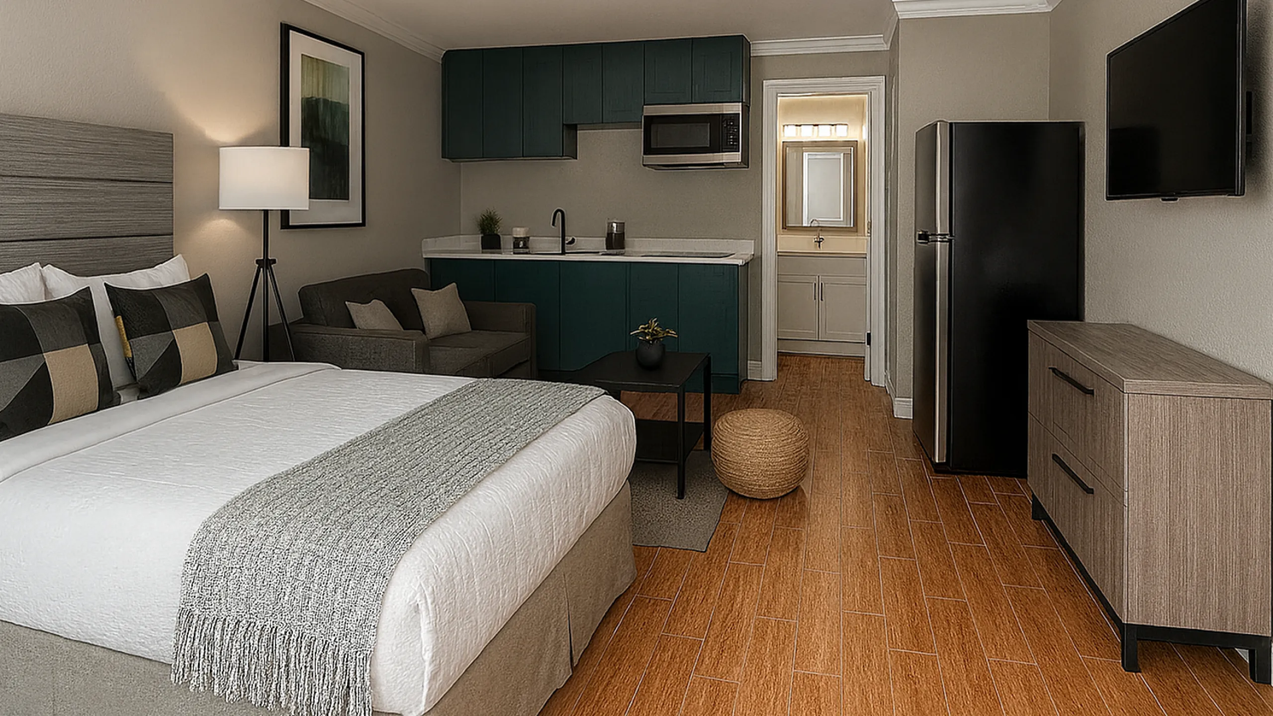 Modern, open-concept studio apartment featuring a cozy bedroom area, sleek kitchenette, and stylish living space with hardwood flooring.