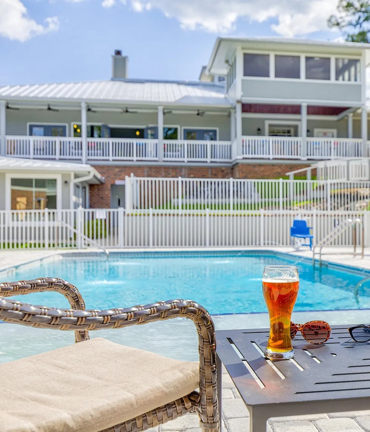 Inviting poolside view with crisp seating and refreshing drinks, surrounded by modern apartment architecture.
