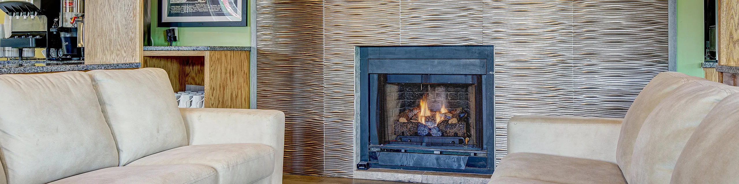Elegant living room with cozy fireplace, modern textured feature wall, and plush beige sofas on sleek wooden flooring.