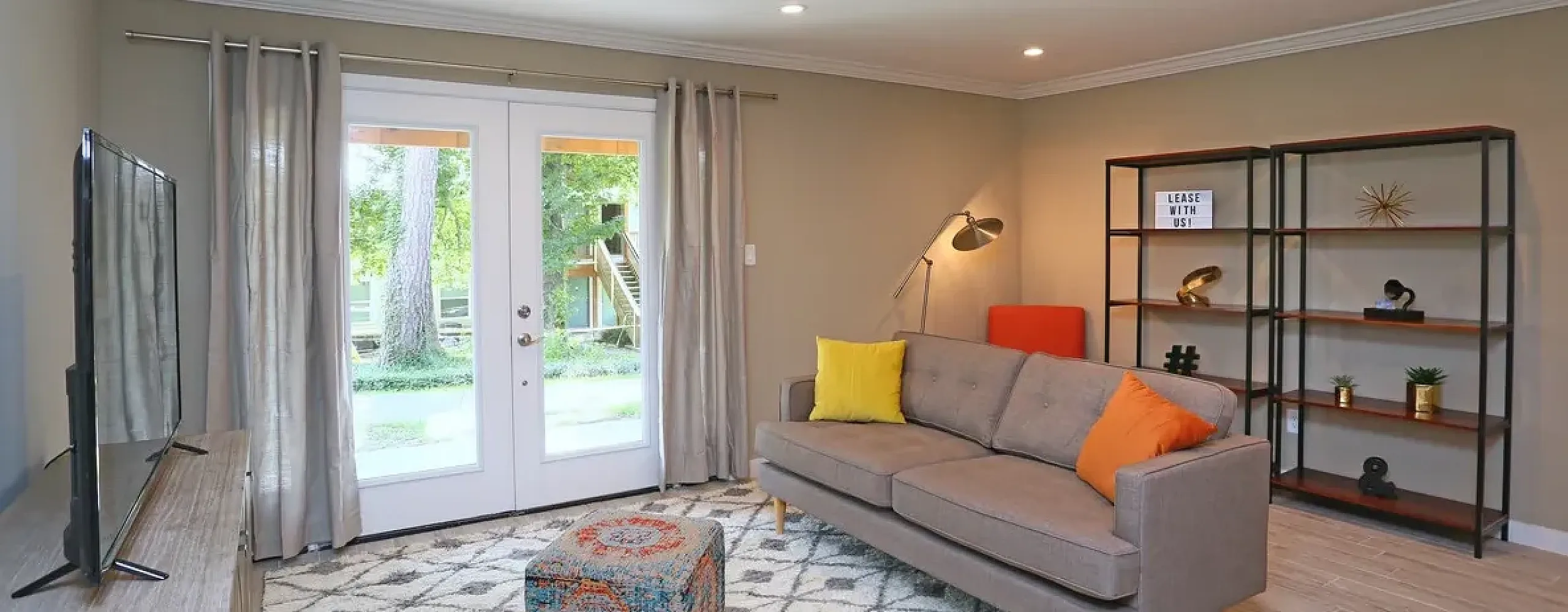 Elegant apartment showcasing a separate bathroom with vanity area and spacious master walk-in closet.