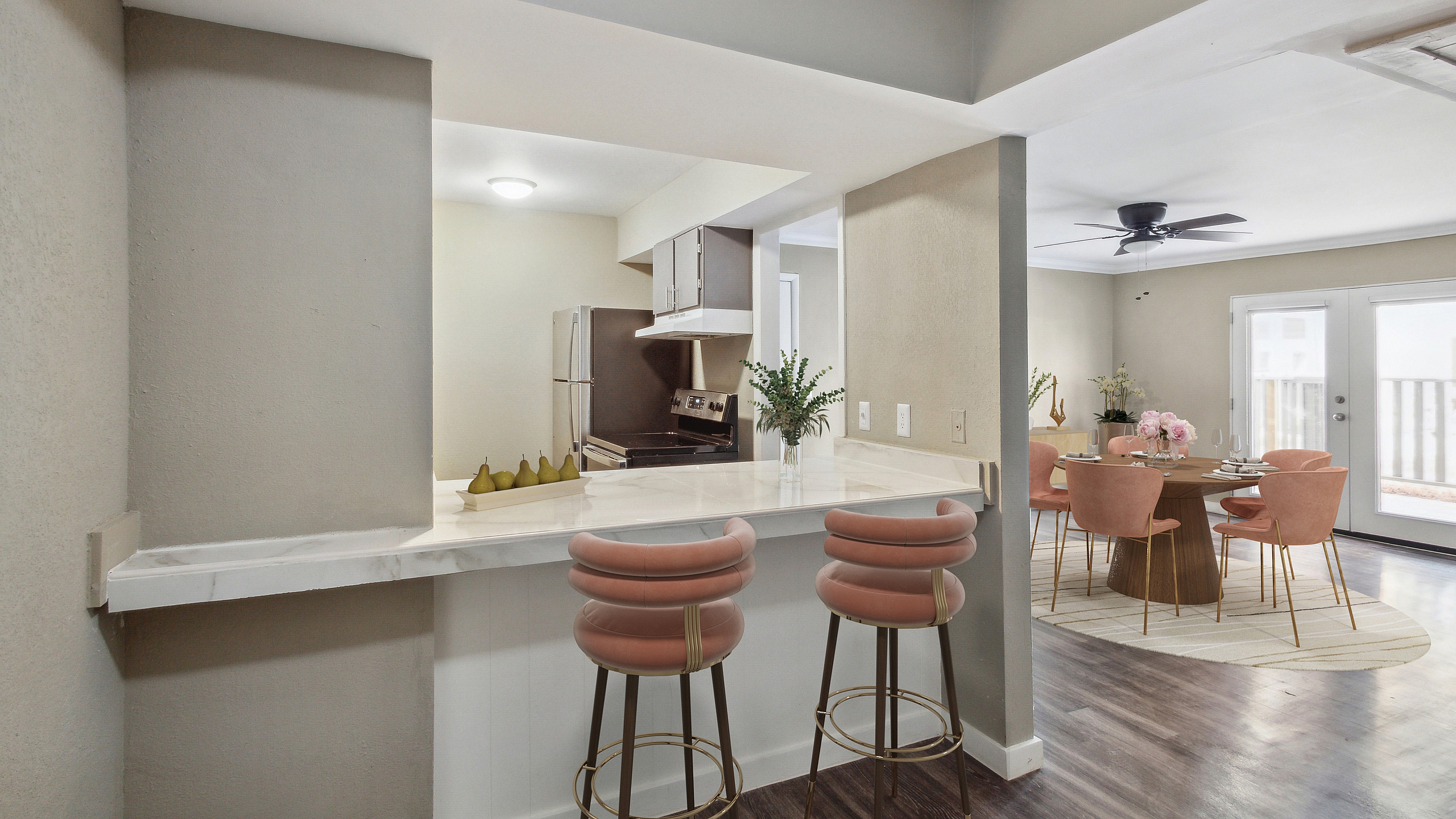 Chic modern interior with a sleek kitchen bar, stylish bar stools, and a spacious dining area with elegant decor.