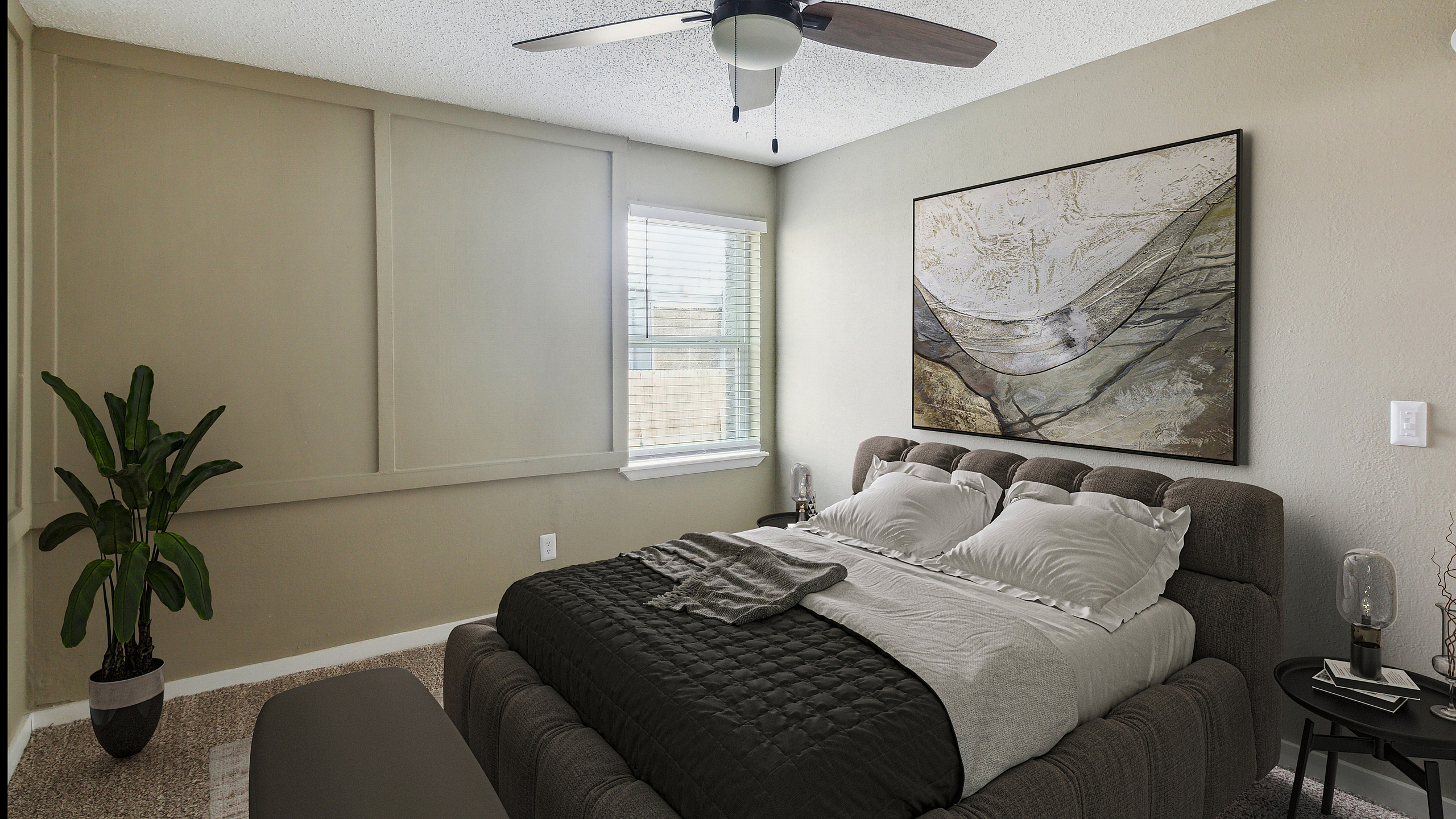Serene bedroom with plush bed, modern ceiling fan, and elegant wall art, offering a cozy and inviting atmosphere.