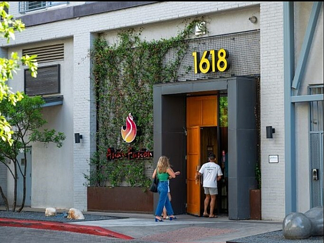 Chic urban entrance to Asian Fusion restaurant with modern architecture and lush greenery at 1618.