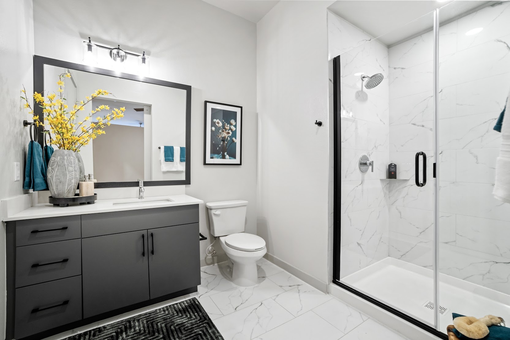 Santa Fe A bathroom with glass shower and marble-style tile