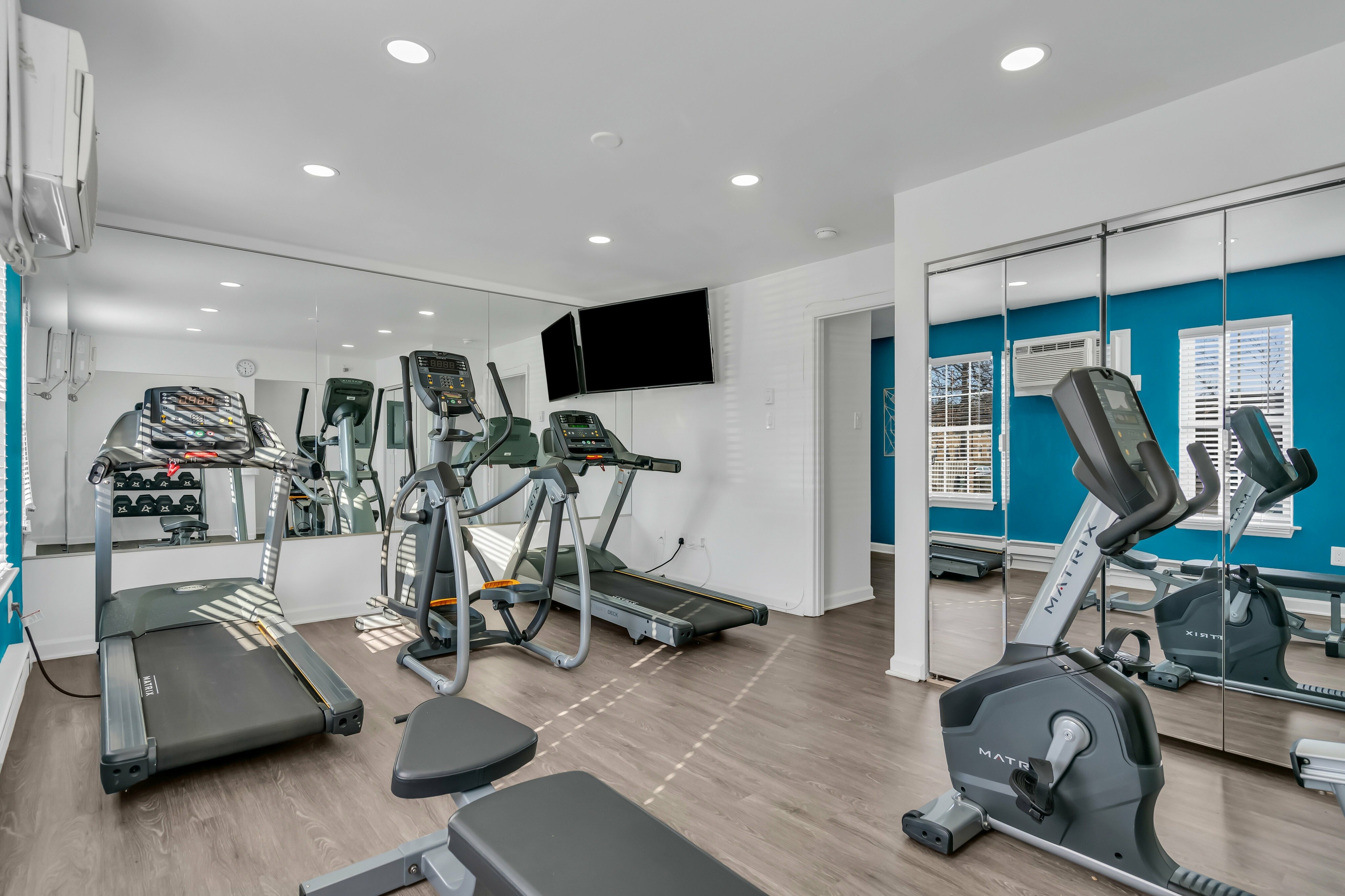 Gym with mirrored walls and equipment
