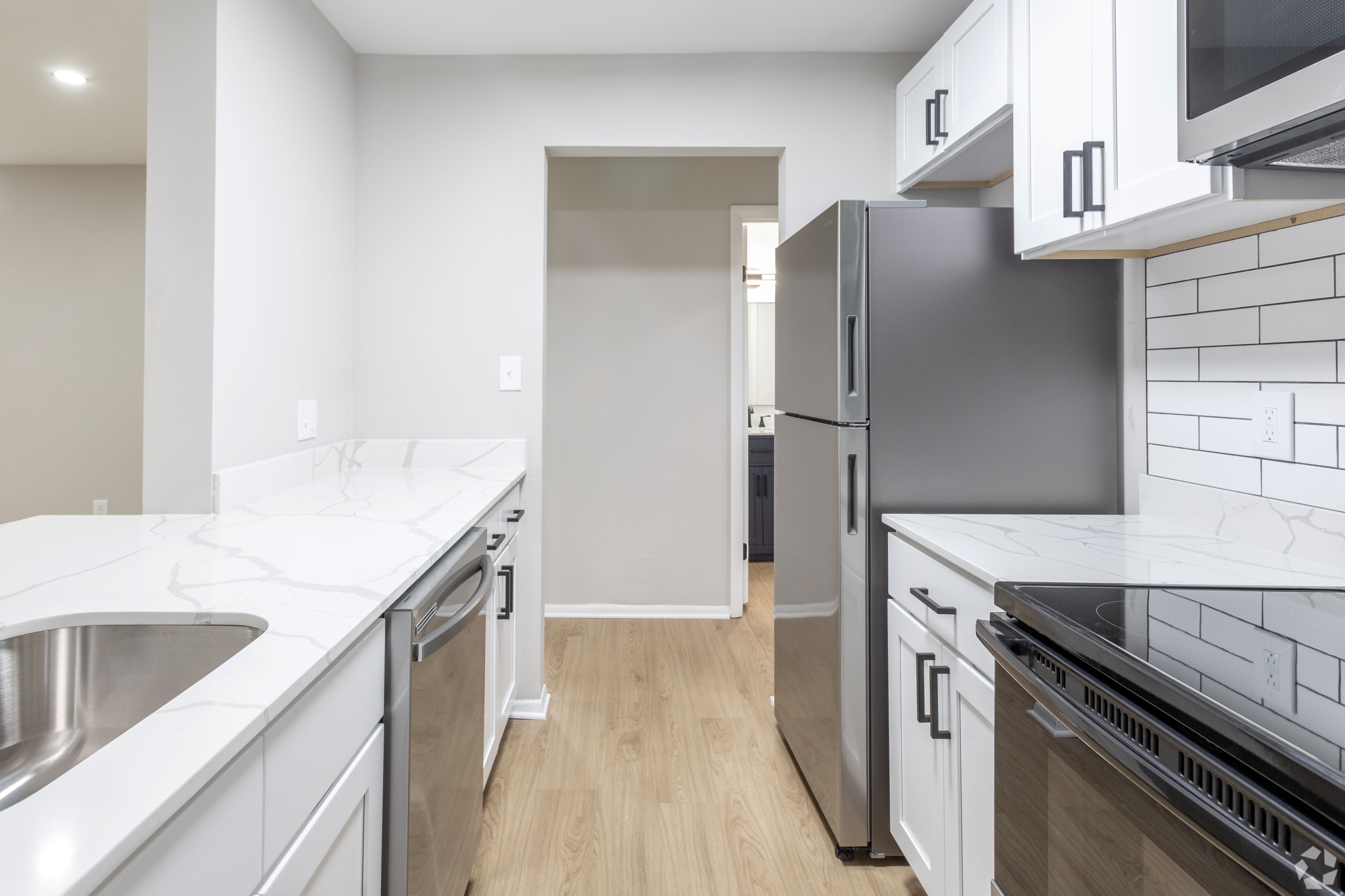 Upgraded Kitchen with White Quartz Counters in an Autumn Columbia apartment.