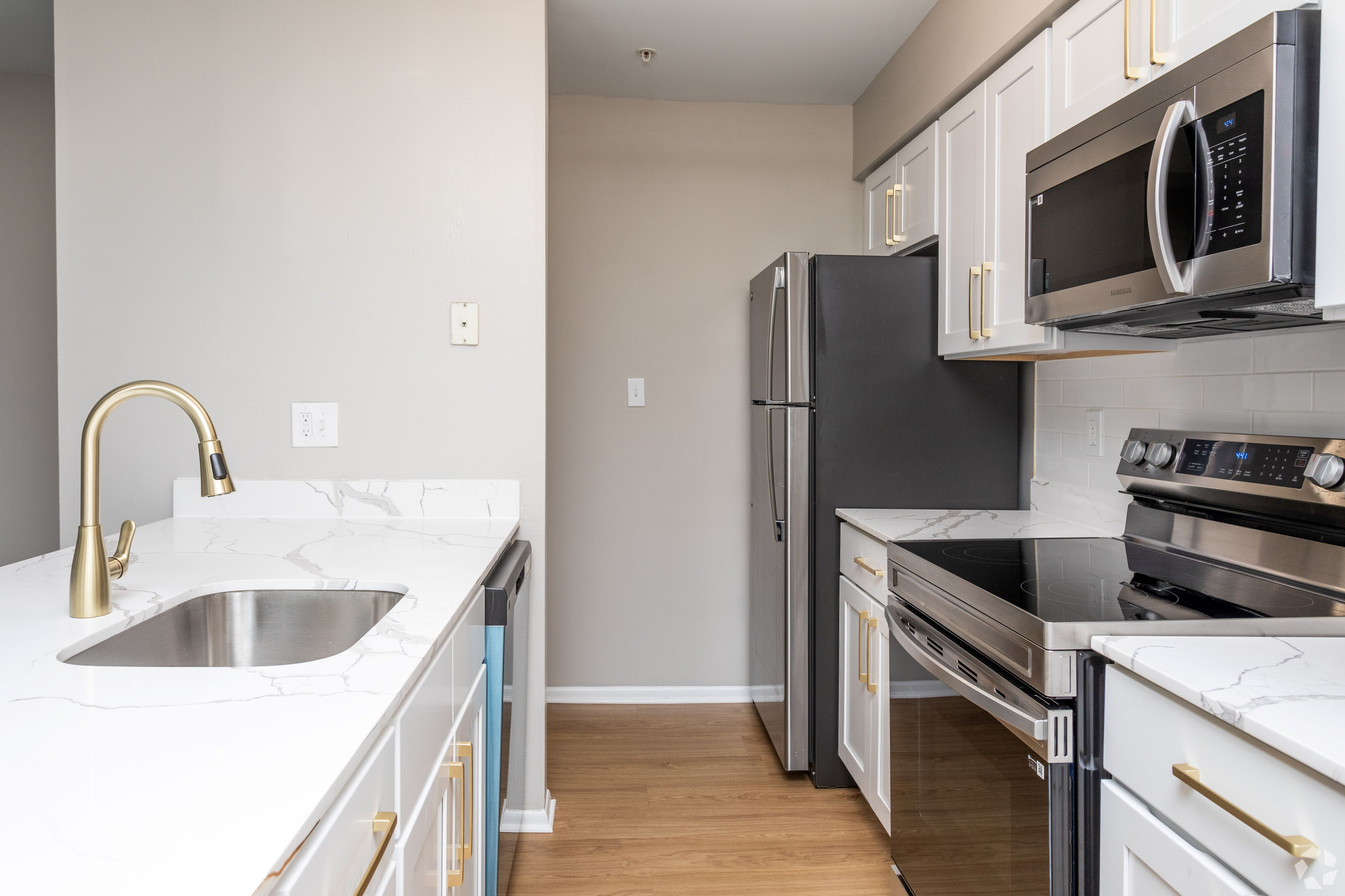 Redesigned two-bedroom home with upgraded kitchen Countertops and White Cabinetry at Autumn Town Center Columbia apartments.