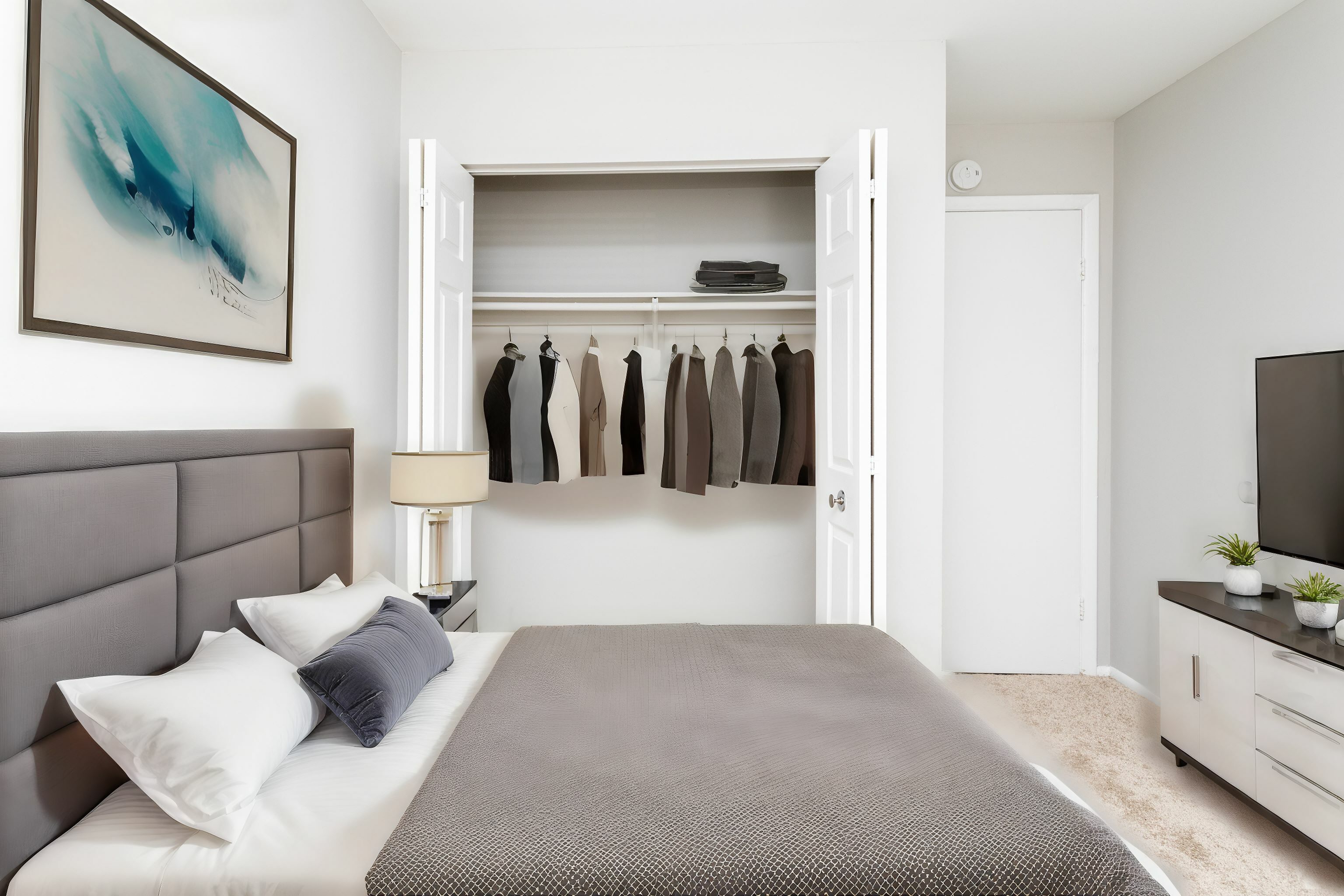 Spacious Bedroom with Queen Size Bed, Nightstands, and Full Size Dresser in an Autumn Town Center apartment.