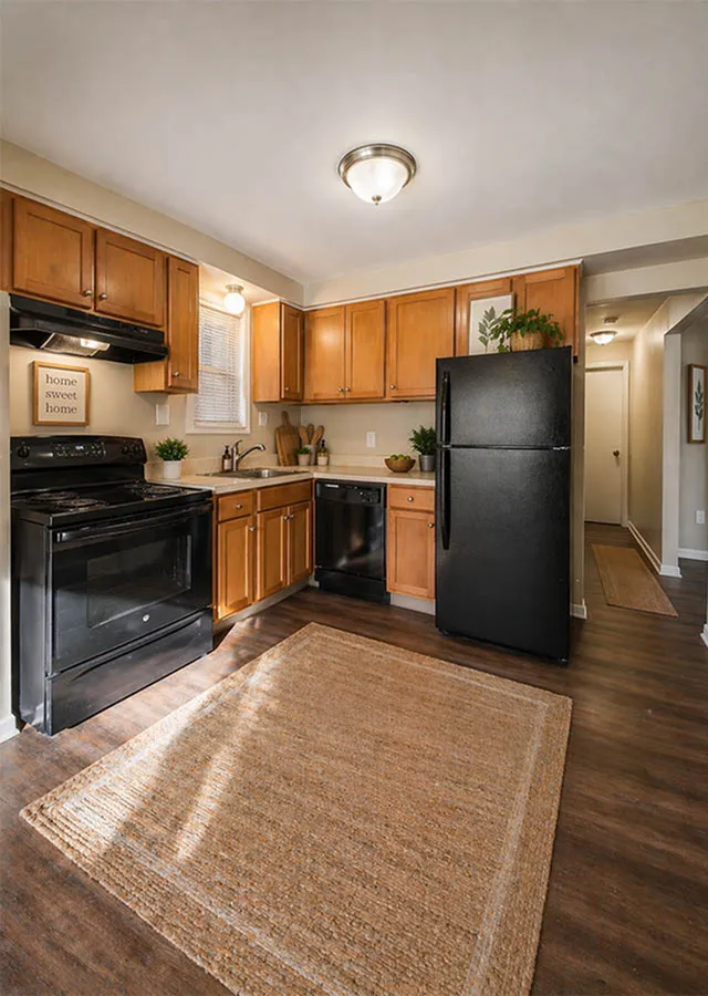 Charming kitchen with warm wooden cabinets, modern appliances, and a cozy ambiance.