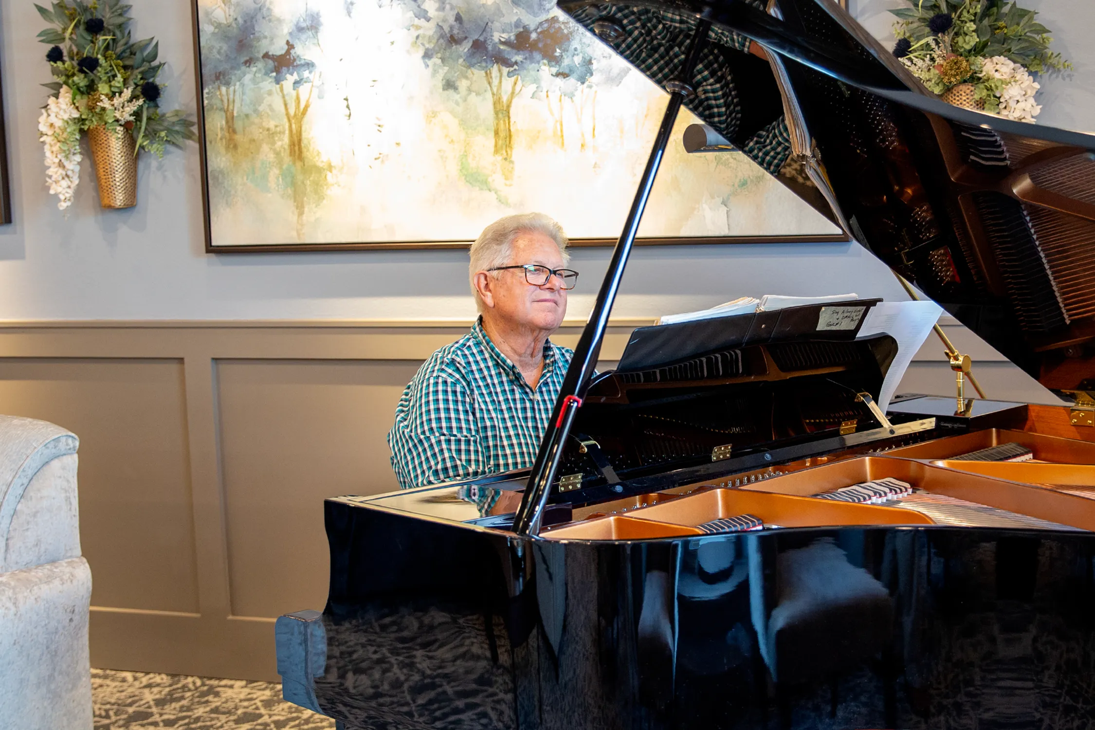 Resident Playing Piano at Attivo Trails Ankeny | Ankeny, Iowa