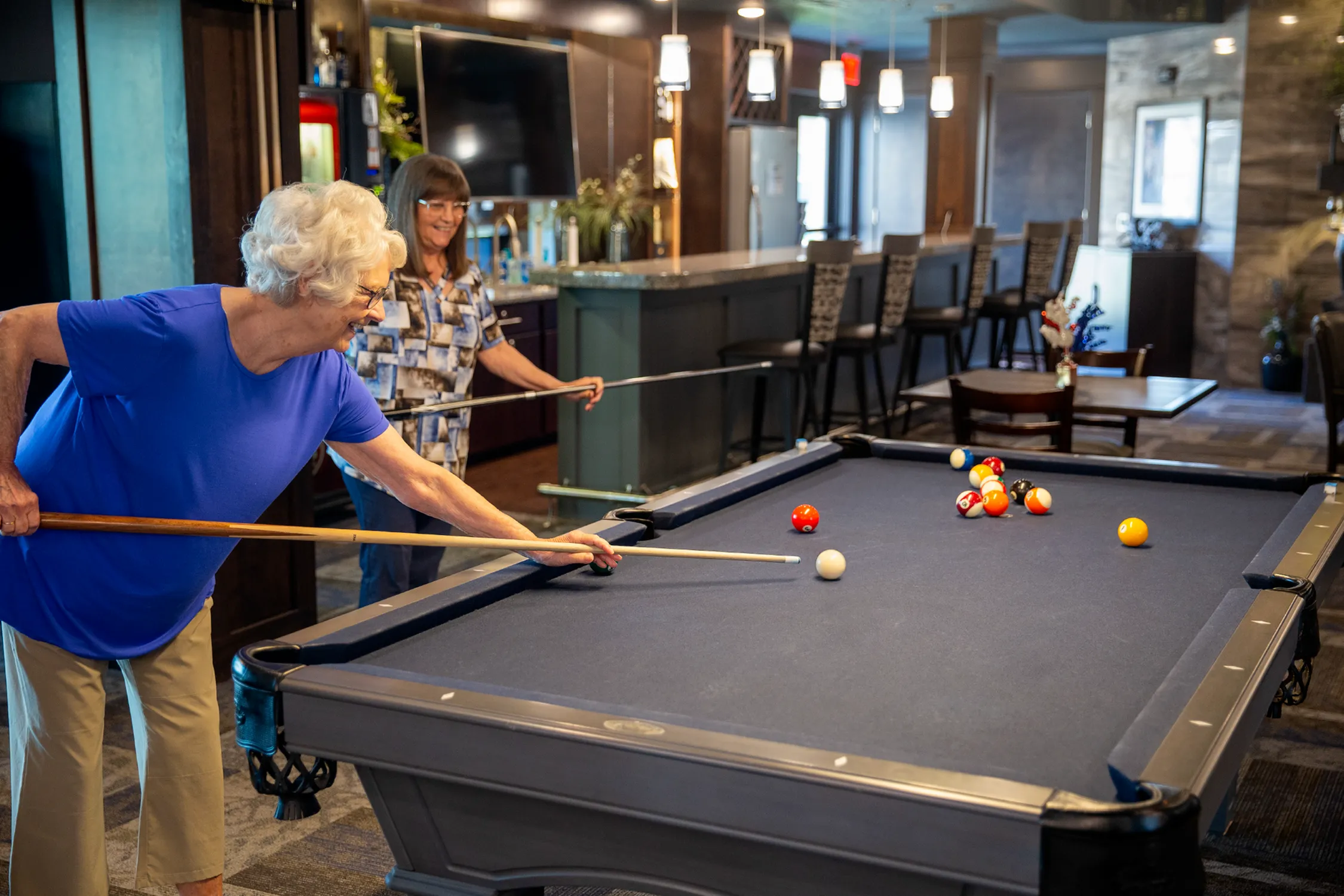 Residents Playing Billiards in Clubhouse | Attivo Trails Waukee | Waukee, Iowa