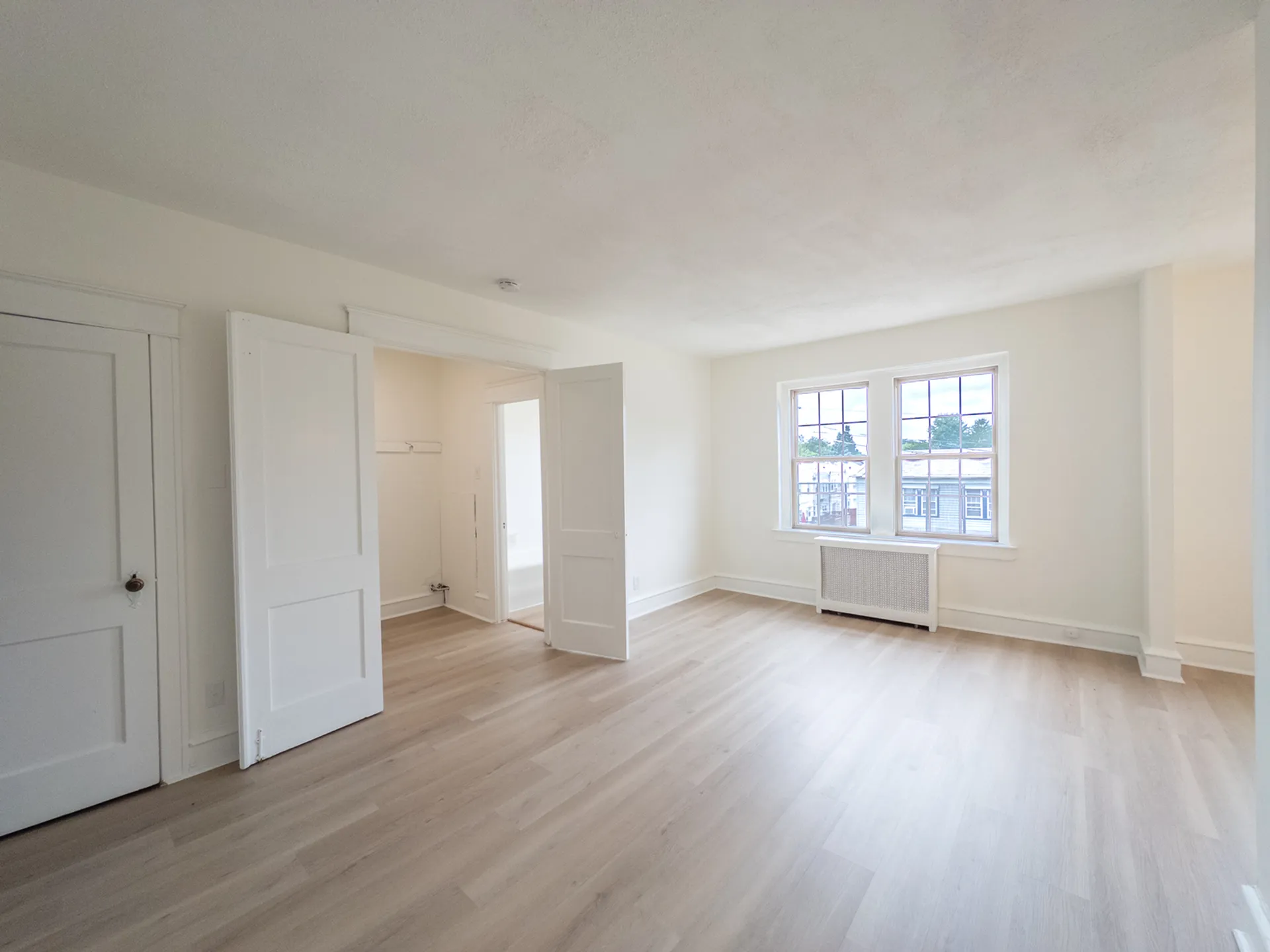 studio apartment with storage closet, big windows, natural light, wood floors