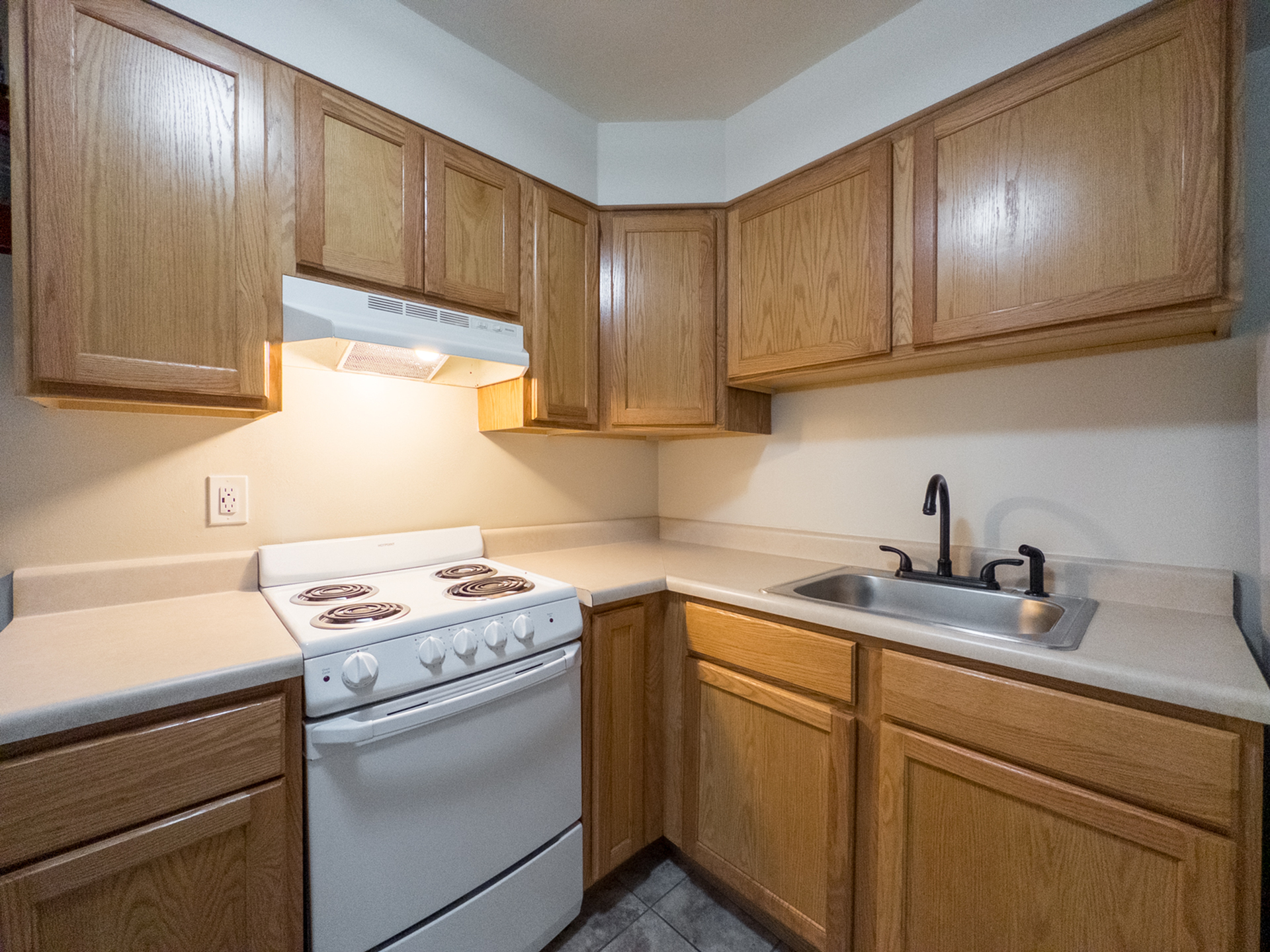 kitchen with range and hood, wood cabinets