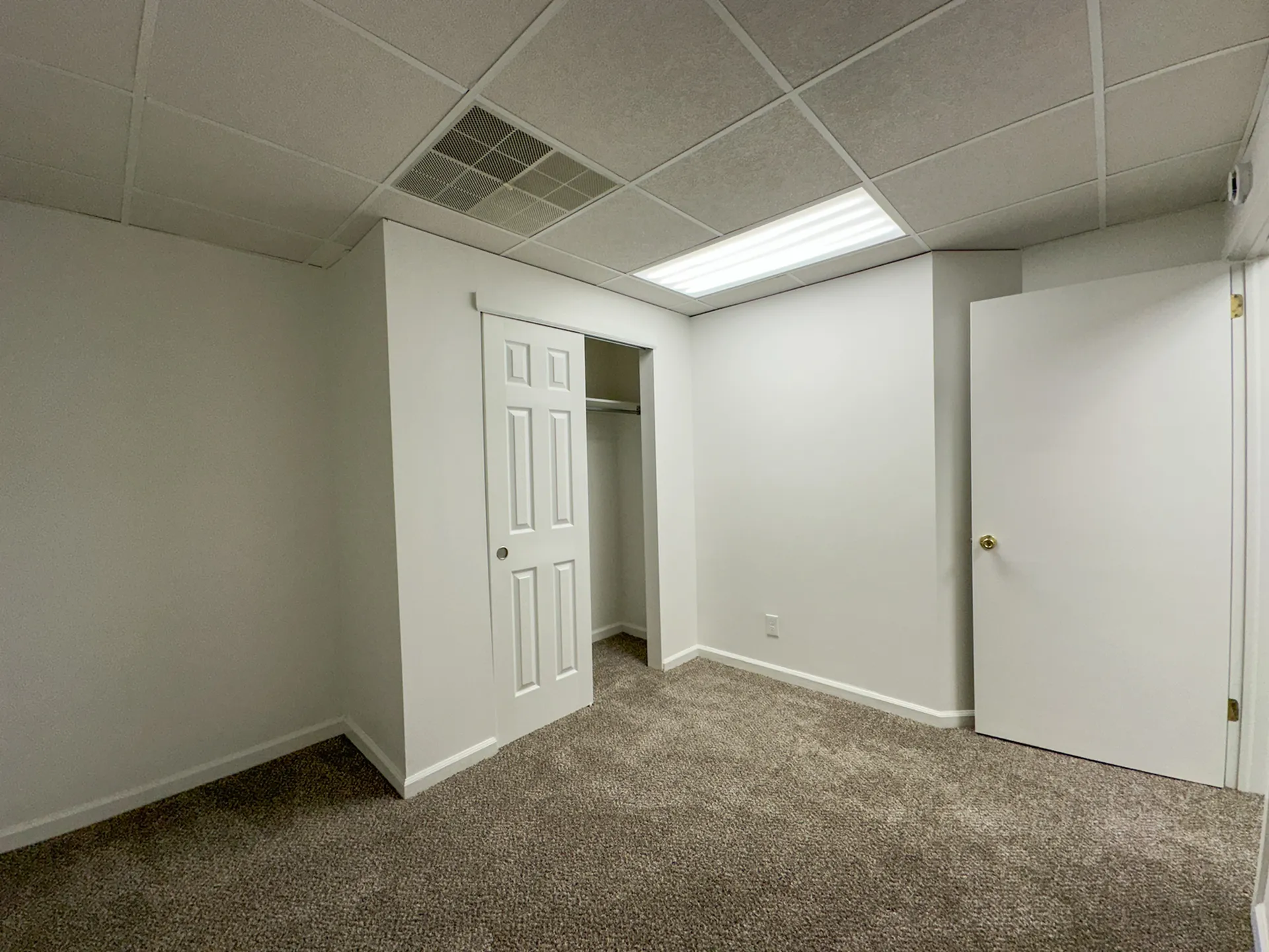 Bright and spacious bedroom with a large closet and plush carpet, perfect for a cozy and comfortable living space.