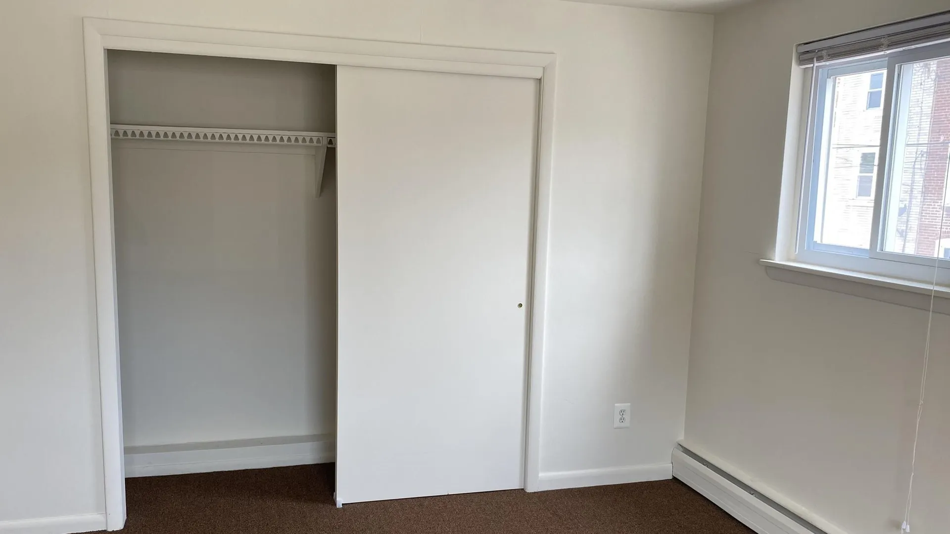 bedroom with closet and window
