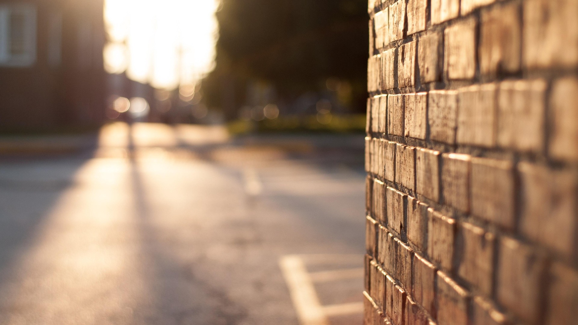brick wall next to parking lot