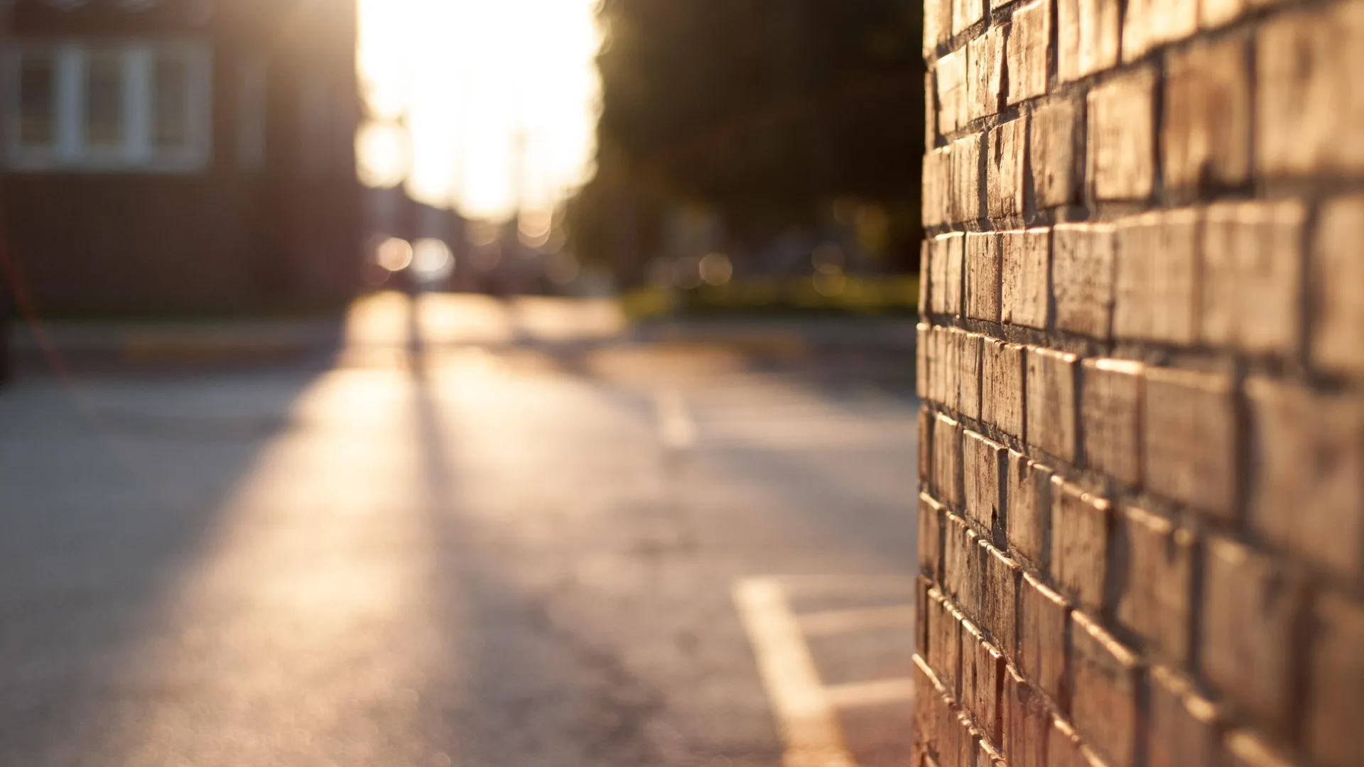 brick wall next to parking lot