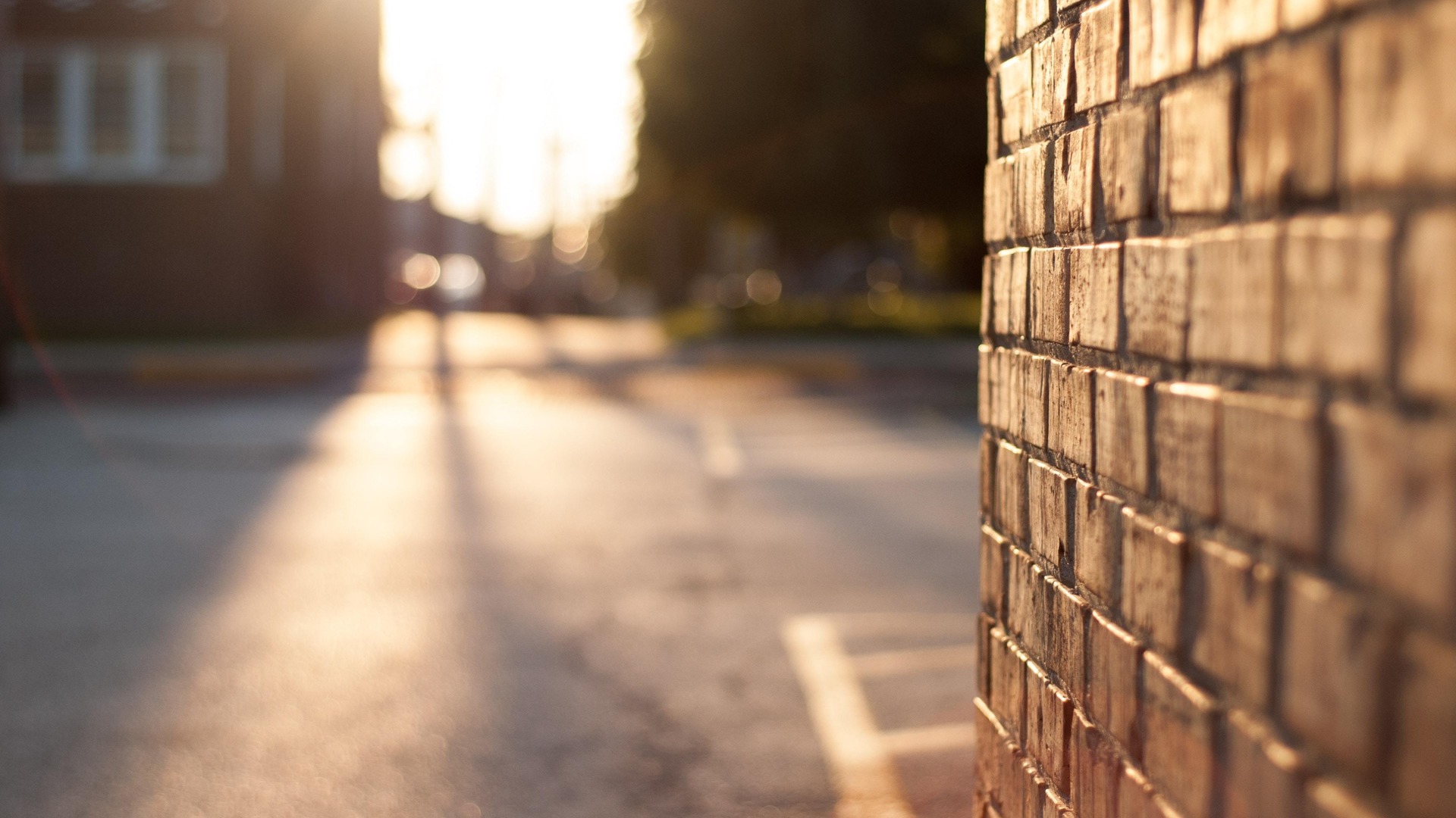 brick wall next to parking lot