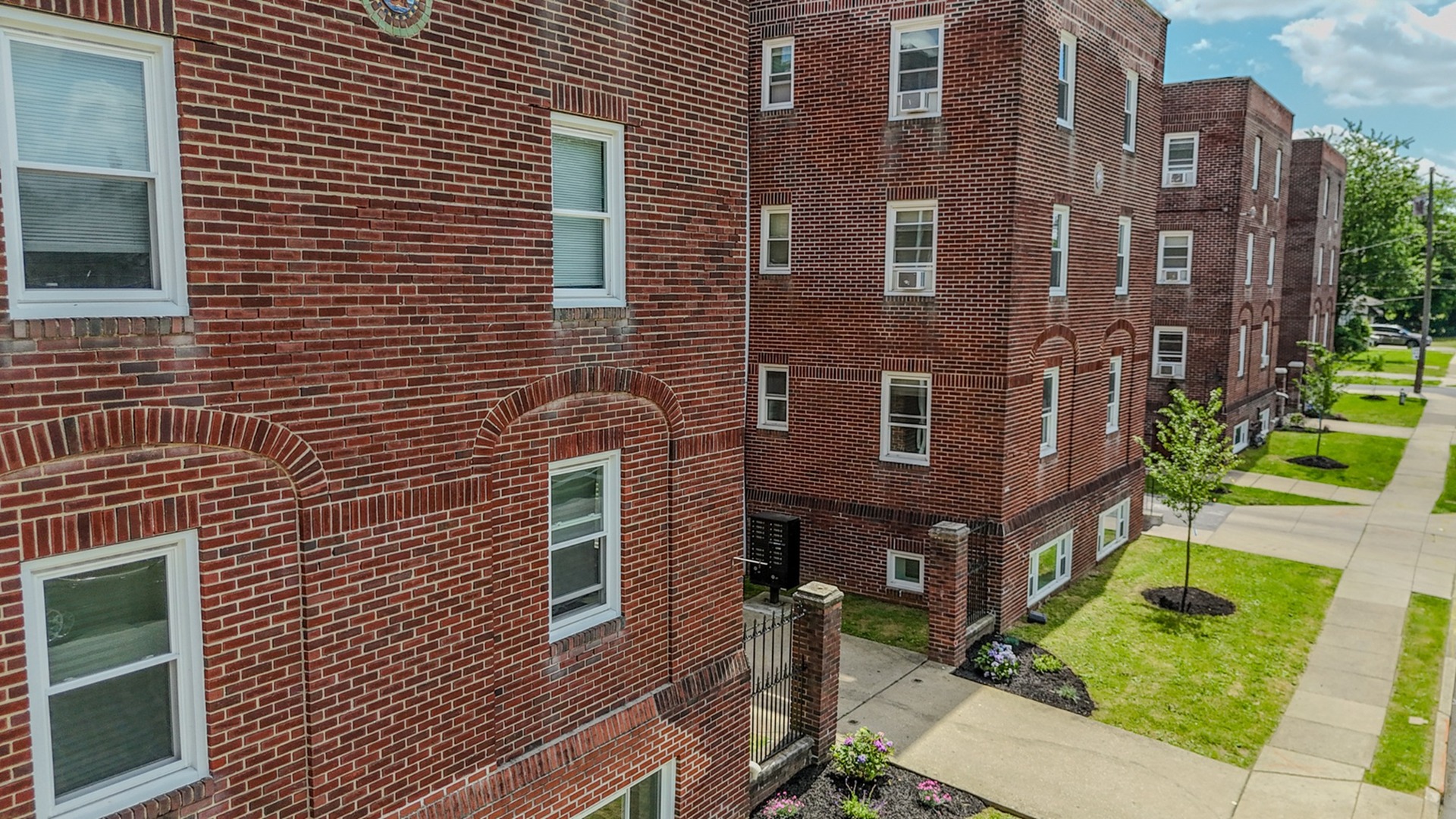 brick apartment buildings with courtyards and sidewalks between grass, folcroft courts apartments