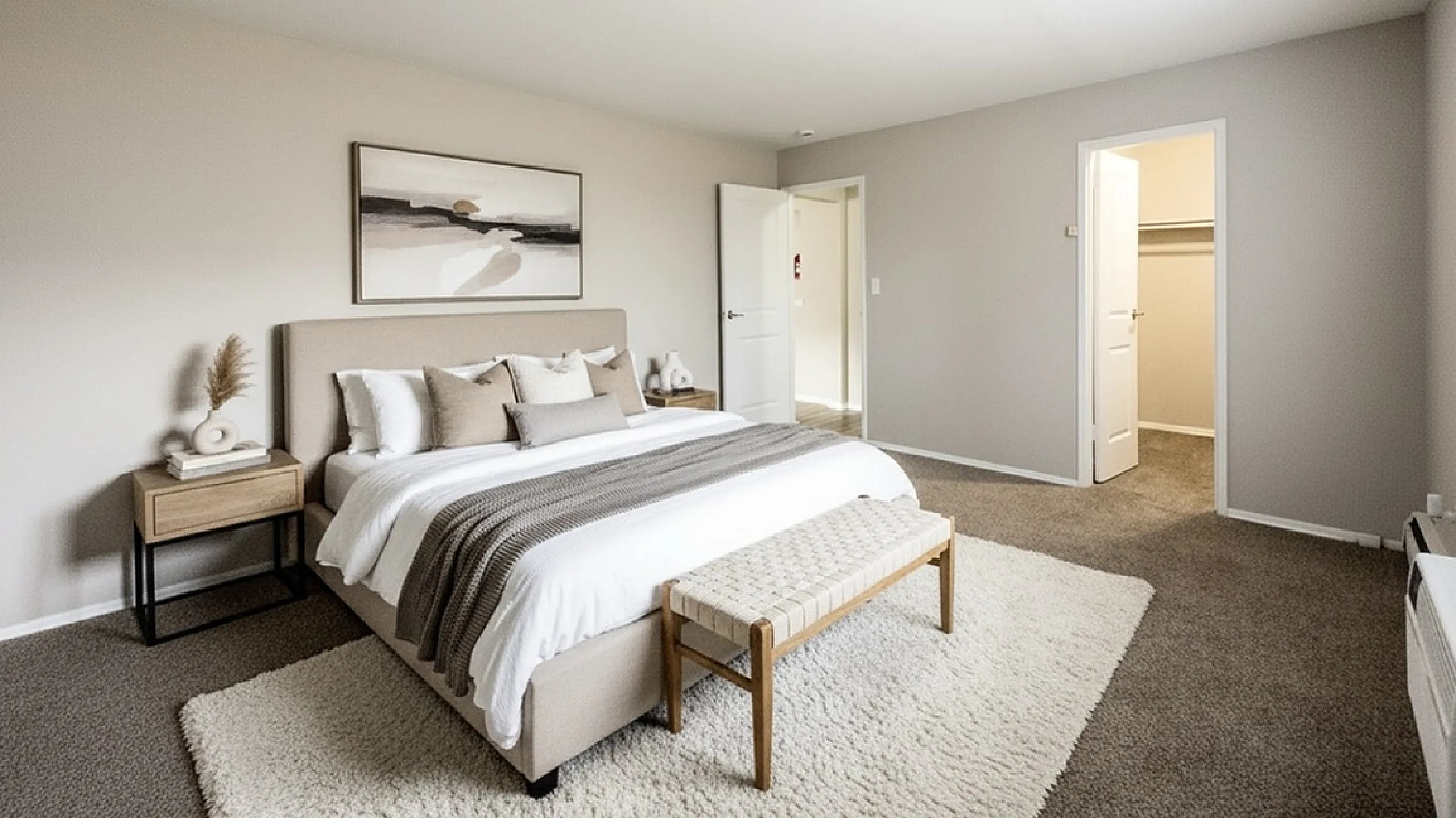 Chic master bedroom with elegant decor, plush carpet, and modern furnishings, offering a serene retreat.