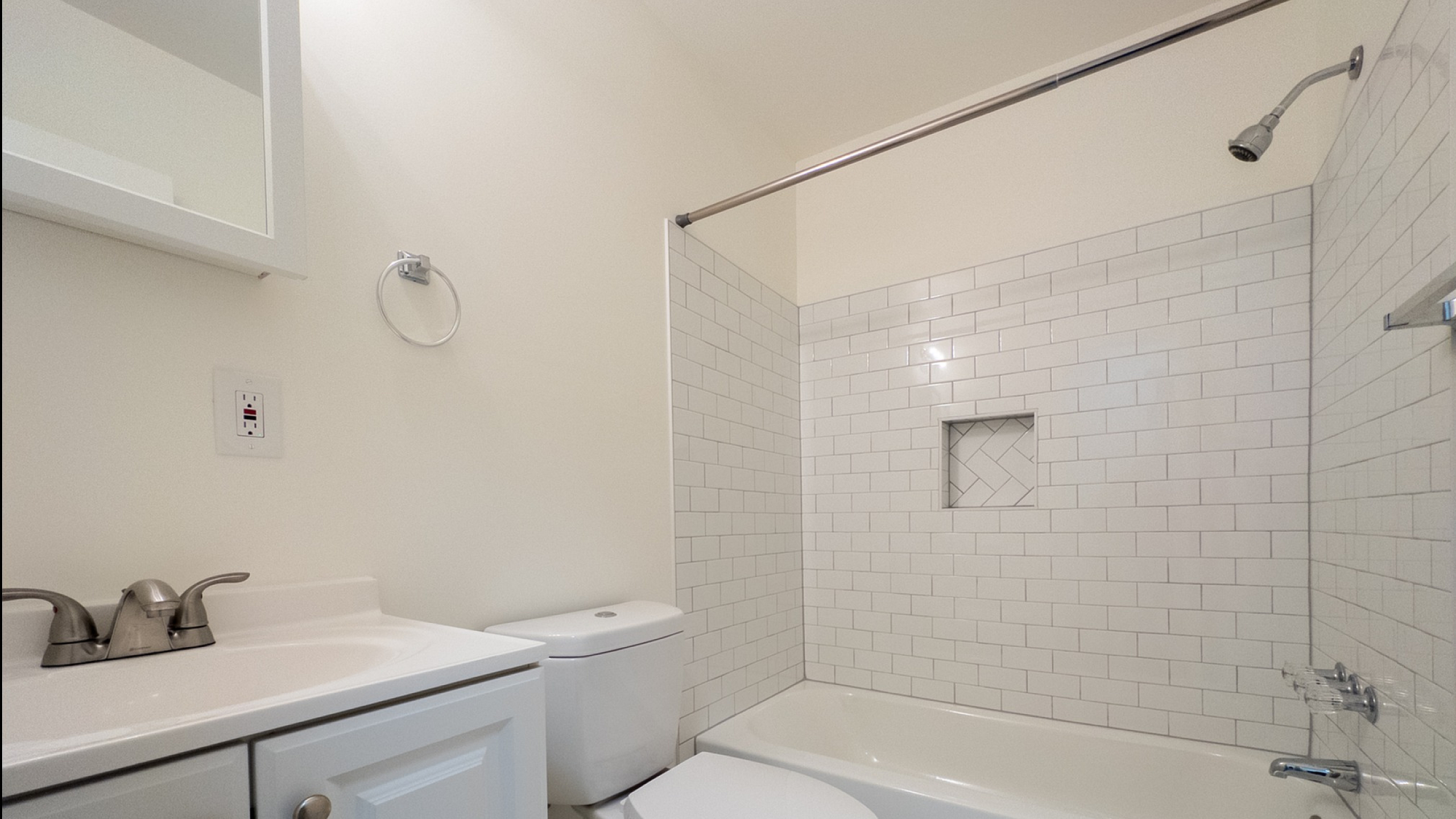 Bright, modern bathroom with sleek white fixtures and stylish subway tile accents.