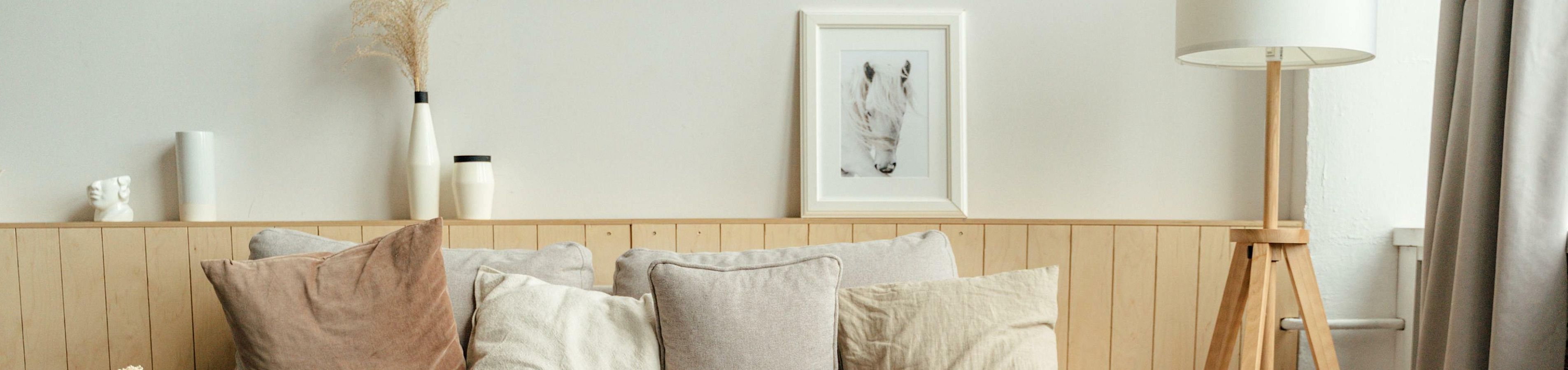 Bright and cozy living room with a chic beige sofa, stylish cushions, and elegant decor creating a serene atmosphere.