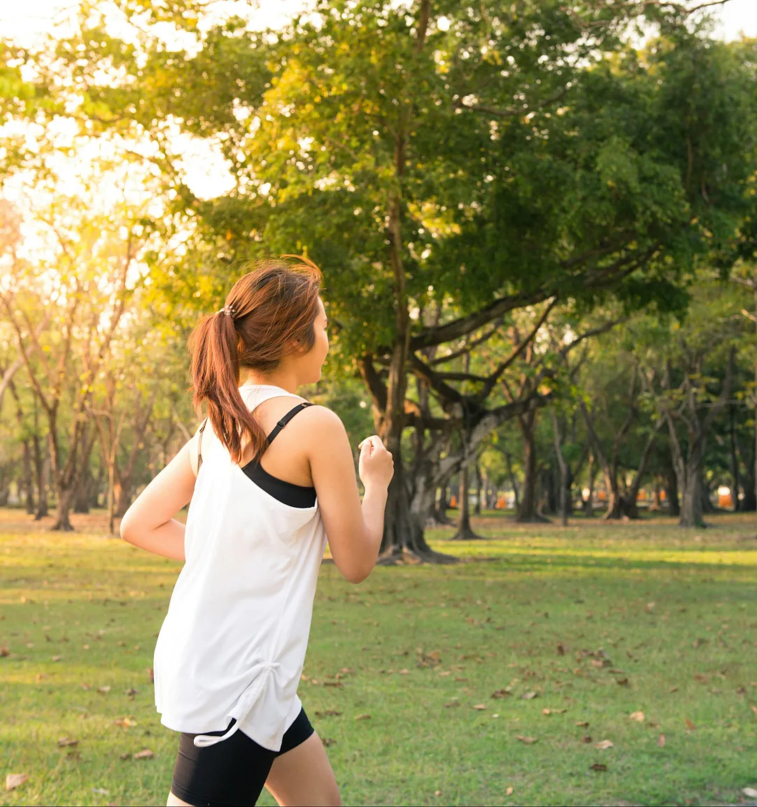 Invigorating outdoor run in a sunlit, lush green park setting.