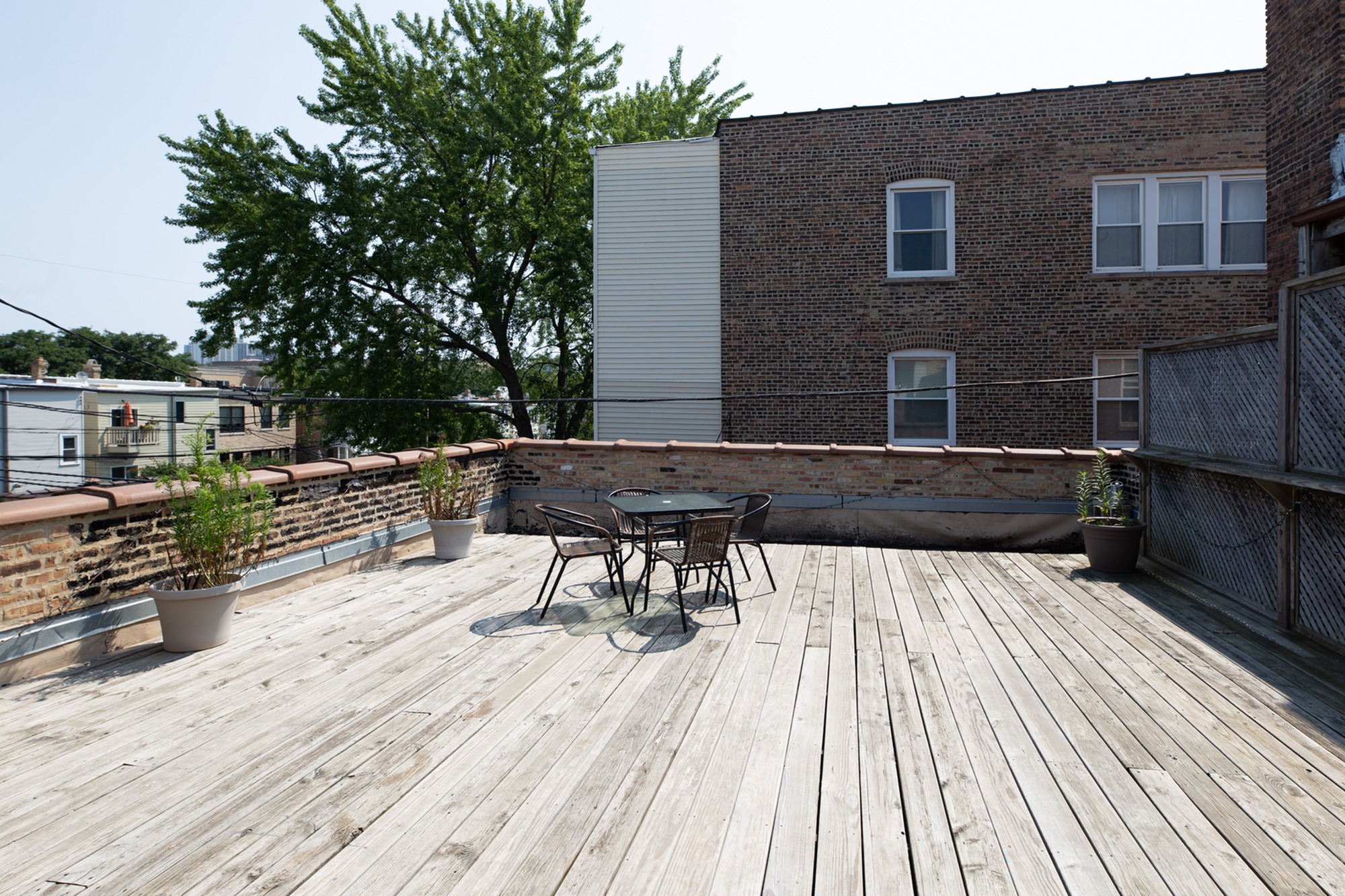 A large shared outdoor wooden deck for summertime use.